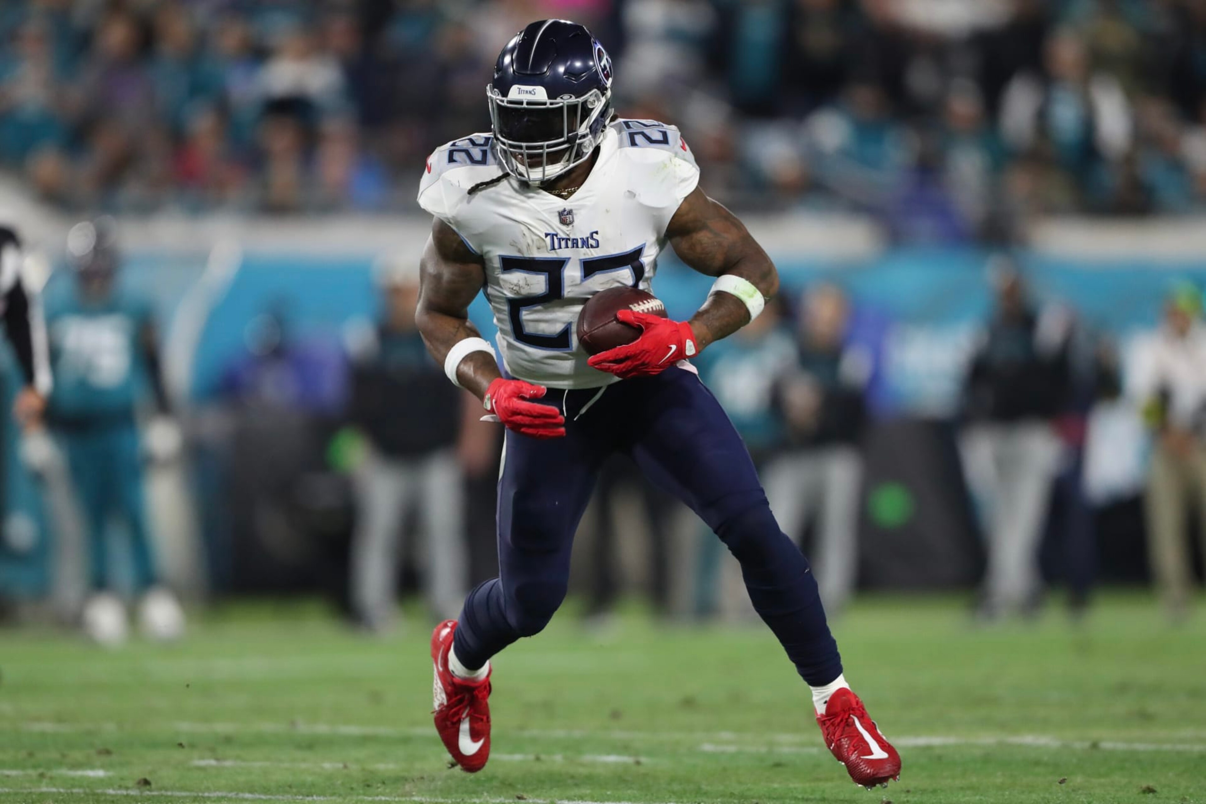 JACKSONVILLE, FLORIDA - JANUARY 07: Derrick Henry #22 of the Tennessee Titans carries the ball during the first half against the Jacksonville Jaguars at TIAA Bank Field on January 07, 2023 in Jacksonville, Florida. (Photo by Courtney Culbreath/Getty Images)