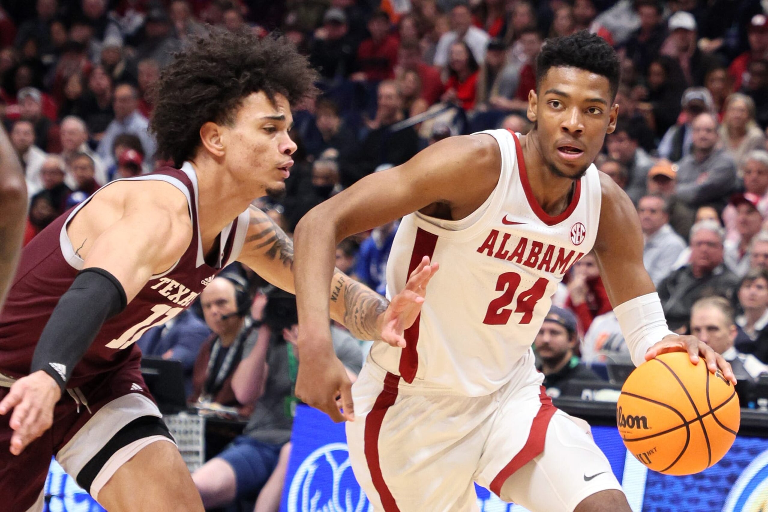 NASHVILLE, TENNESSEE - MARCH 12: Brandon Miller #24 of the Alabama Crimson Tide drives to the basket against Andersson Garcia #11 of the Texas A&M Aggies during the first half in the SEC Basketball Tournament Championship game at Bridgestone Arena on March 12, 2023 in Nashville, Tennessee. (Photo by Andy Lyons/Getty Images)