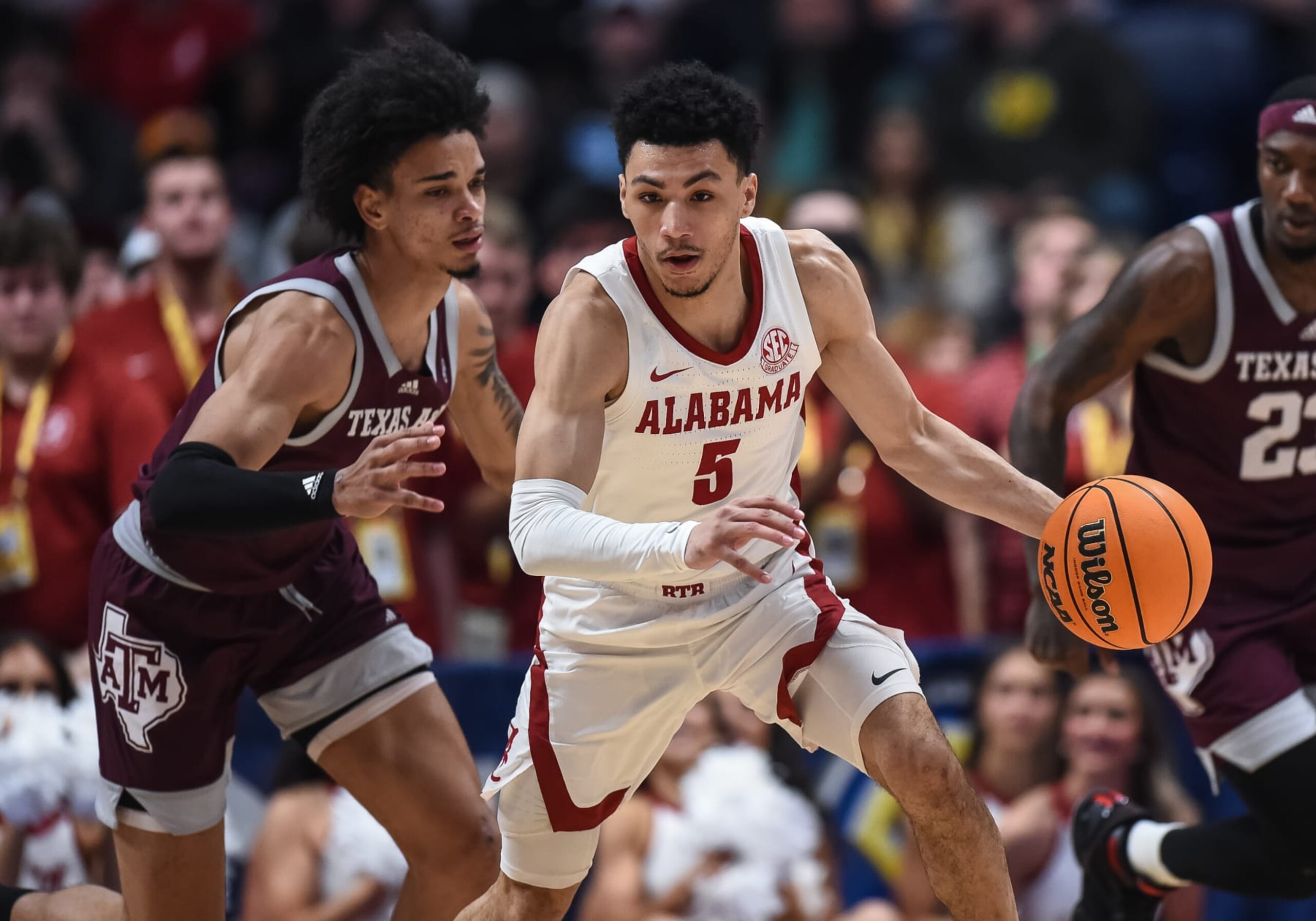 NASHVILLE, TN - MARCH 12: Alabama Crimson Tide guard Jahvon Quinerly (5) controls the ball against Texas A&M Aggies forward Andersson Garcia (11) during the SEC Mens Basketball Tournament championship game between the Alabama Crimson Tide and the Texas A&M Aggies on March 12, 2023 at Bridgestone Arena in Nashville, TN. (Photo by Bryan Lynn/Icon Sportswire via Getty Images)