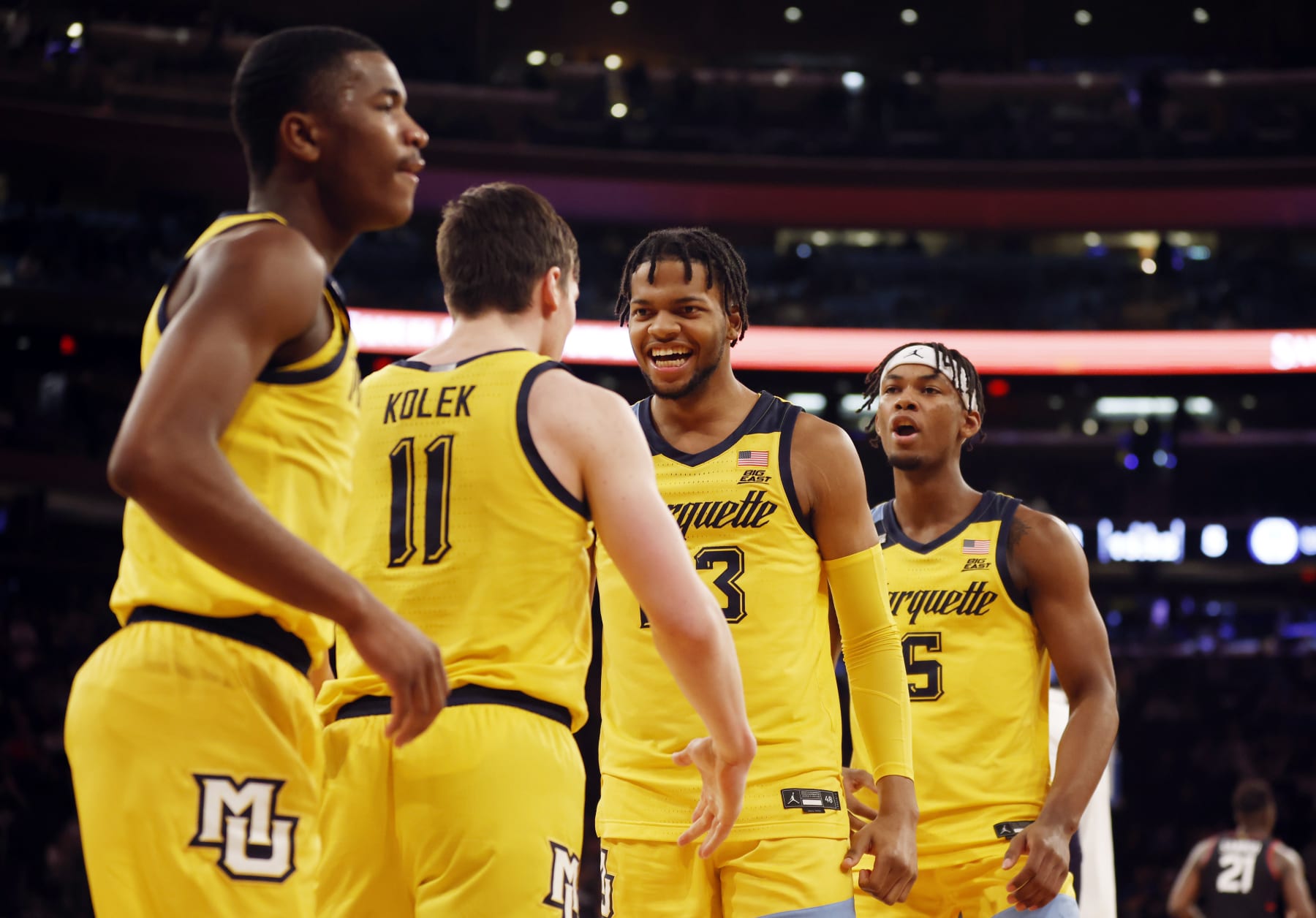 NEW YORK, NEW YORK - MARCH 10: Chase Ross #5 and Oso Ighodaro #13 react with Tyler Kolek #11 of the Marquette Golden Eagles during the first half against the Connecticut Huskies in the Semifinal round of the Big East Basketball Tournament at Madison Square Garden on March 10, 2023 in New York City. (Photo by Sarah Stier/Getty Images)