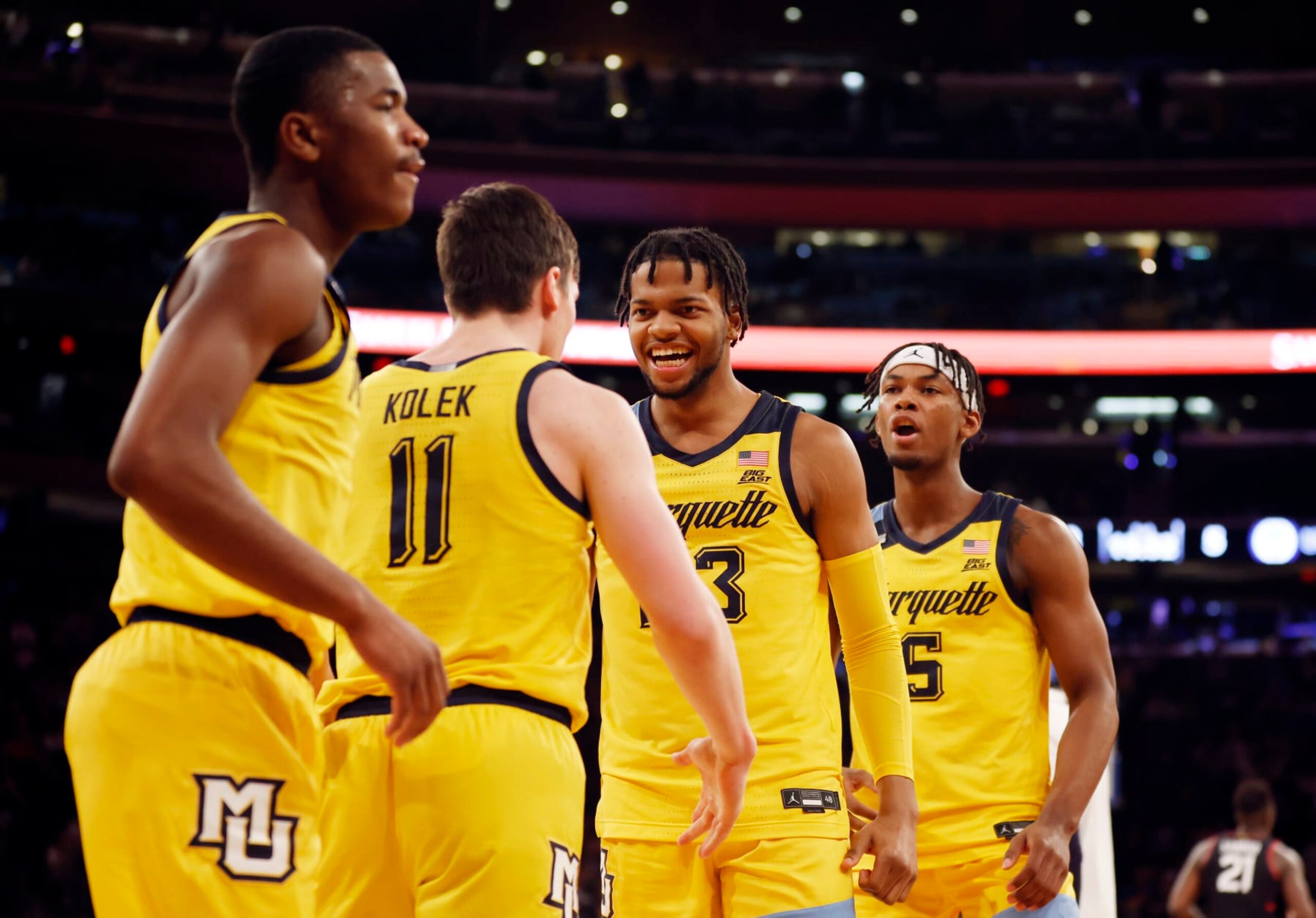 NEW YORK, NEW YORK - MARCH 10: Chase Ross #5 and Oso Ighodaro #13 react with Tyler Kolek #11 of the Marquette Golden Eagles during the first half against the Connecticut Huskies in the Semifinal round of the Big East Basketball Tournament at Madison Square Garden on March 10, 2023 in New York City. (Photo by Sarah Stier/Getty Images)