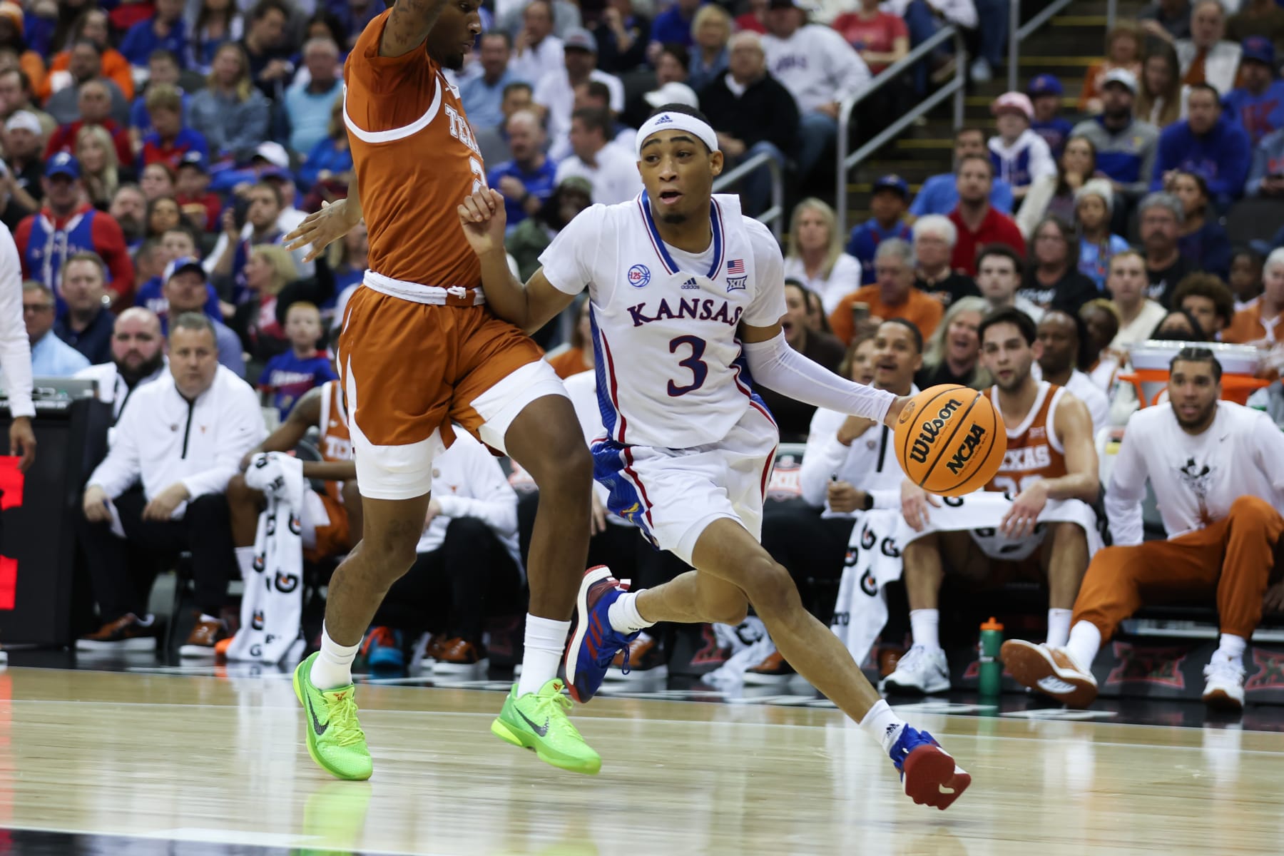 KANSAS CITY, MO - MARCH 11: Kansas Jayhawks guard Dajuan Harris Jr. (3) drives the baseline against Texas Longhorns guard Arterio Morris (2) in the first half of the Big 12 basketball tournament championship game between the Texas Longhorns and Kansas Jayhawks on March 11, 2023 at T-Mobile Center in Kansas City, MO. (Photo by Scott Winters/Icon Sportswire via Getty Images)