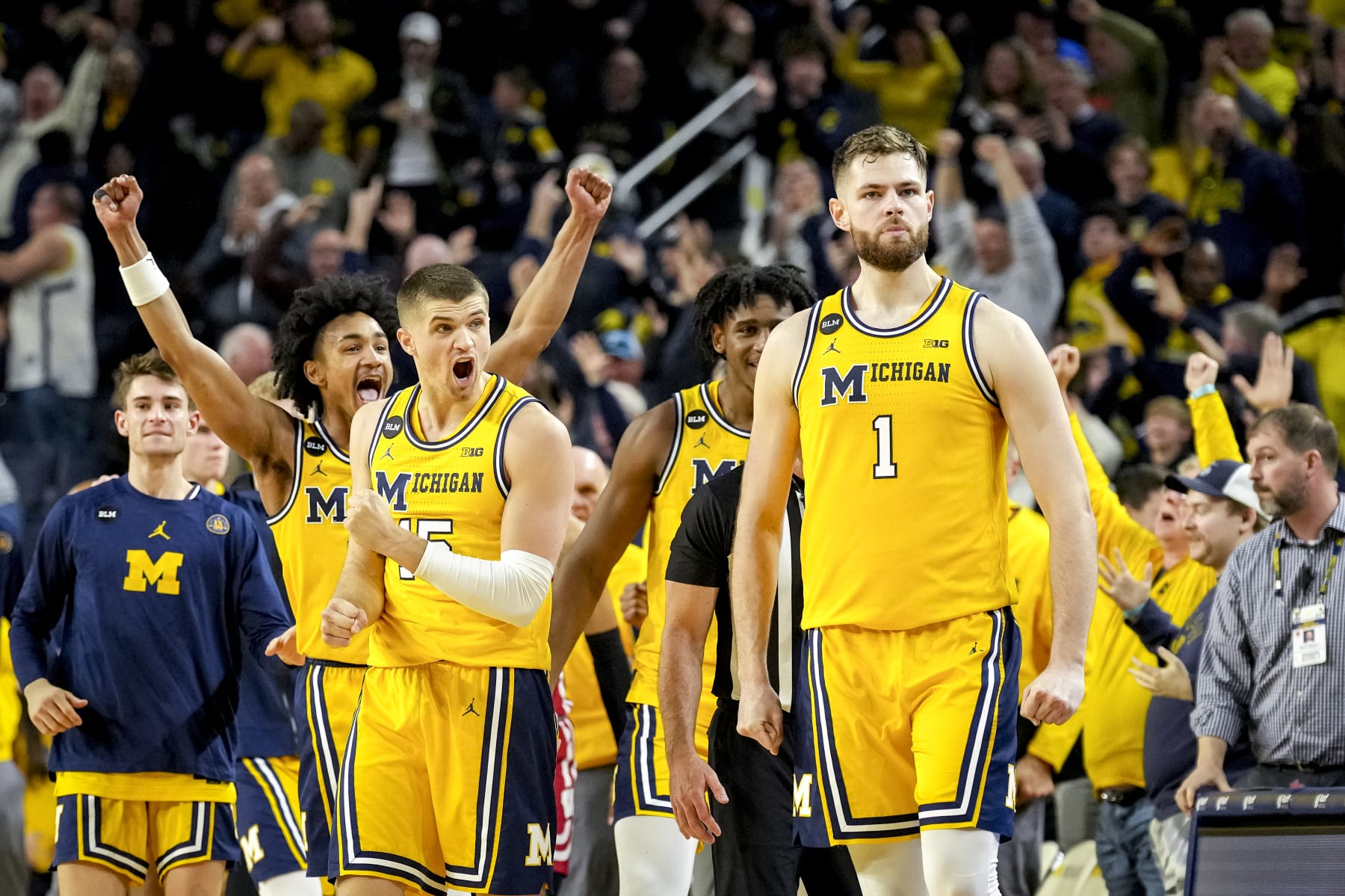 ANN ARBOR, MICHIGAN - FEBRUARY 26: Kobe Bufkin #2 and Joey Baker #15 of the Michigan Wolverines react after Hunter Dickinson #1 of the Michigan Wolverines made a shot that forced the game into overtime against the Wisconsin Badgers during the second half at Crisler Arena on February 26, 2023 in Ann Arbor, Michigan. (Photo by Nic Antaya/Getty Images)