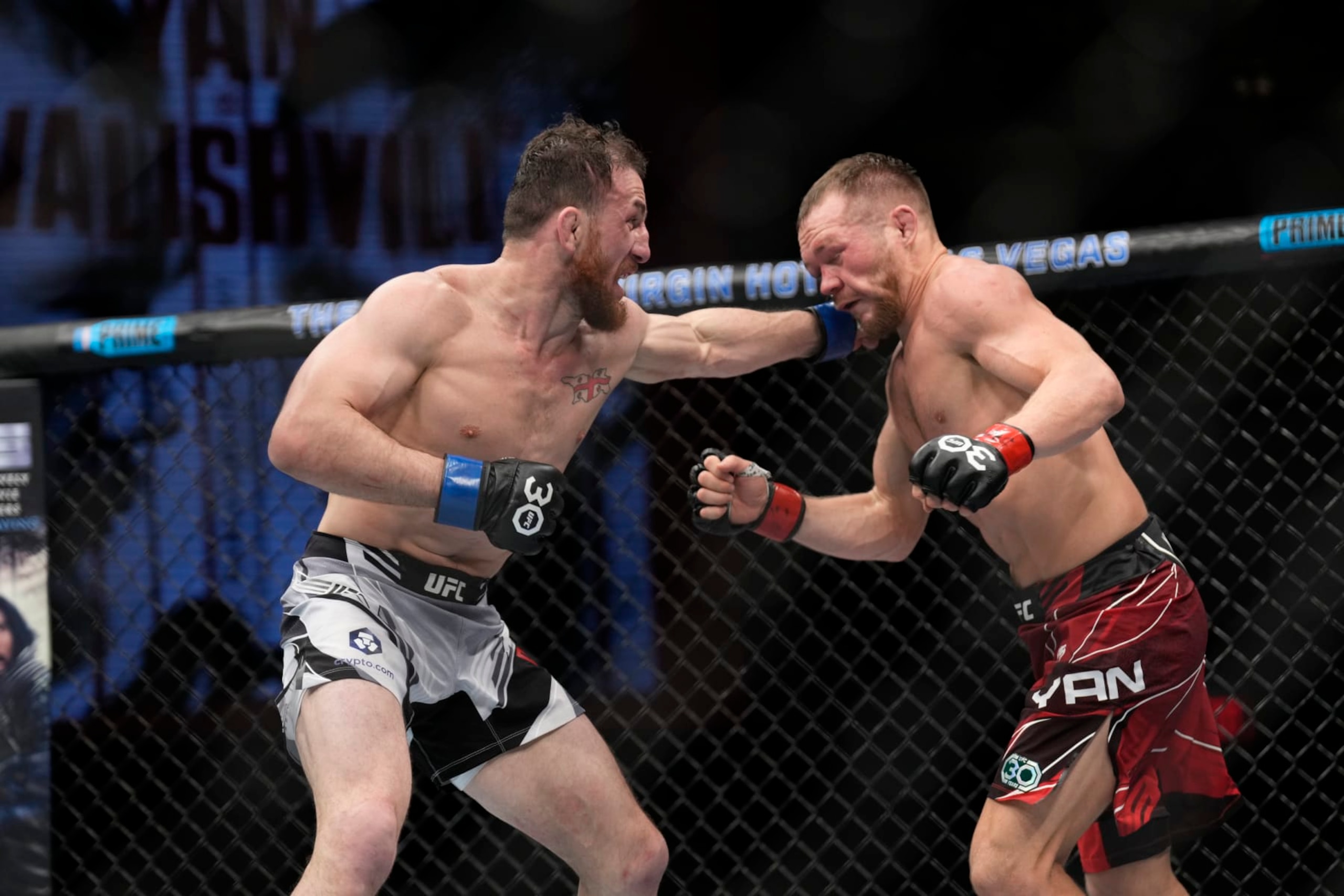 Merab Dvalishvili punches Petr Yan. 