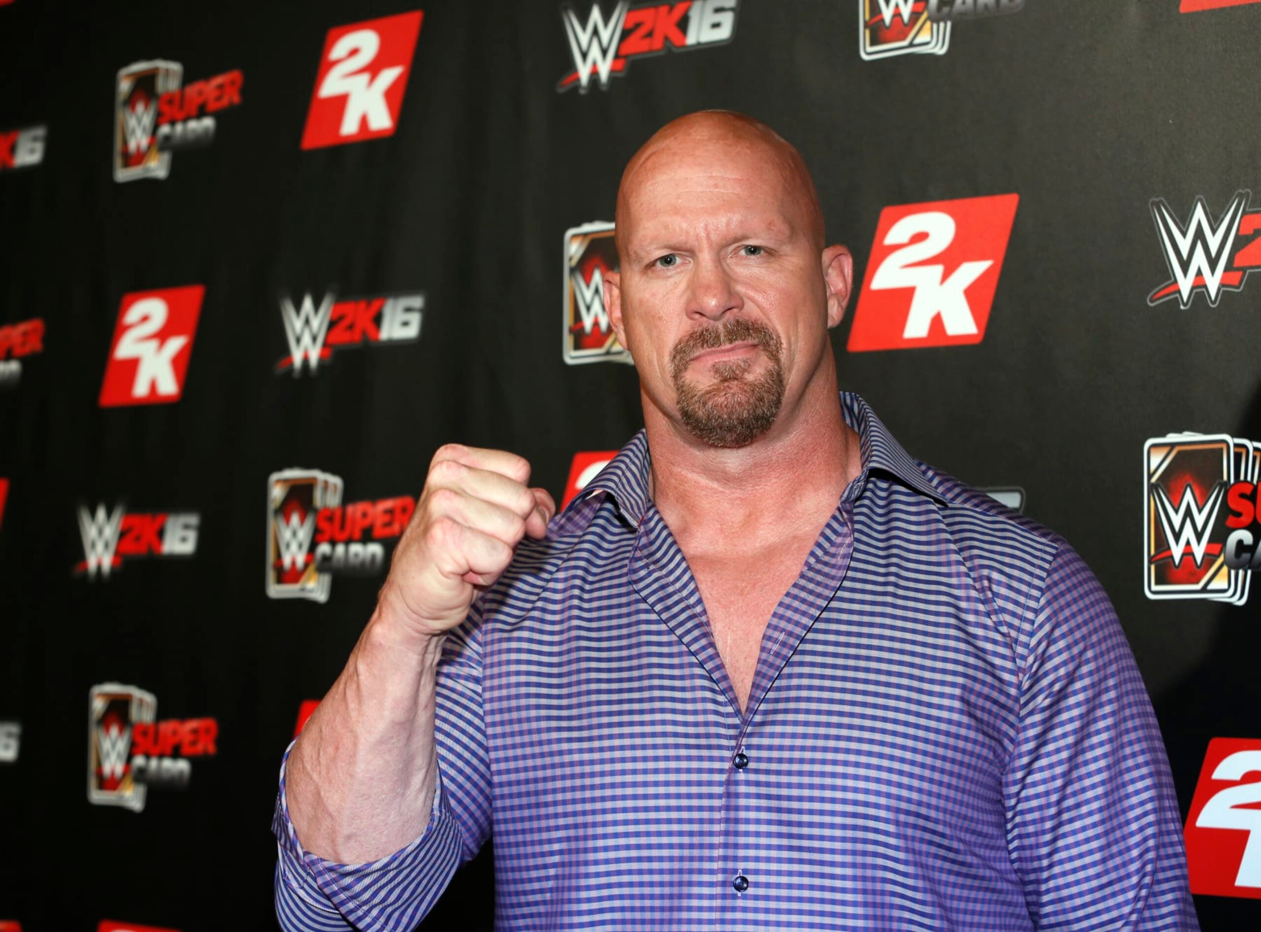 IMAGE DISTRIBUTED FOR 2K - WWE Hall of Famer and WWE 2K16 cover, Superstar Stone Cold Steve Austin arrives on the red carpet at the WWE 2K SummerSlam Kickoff in New York, N.Y., on Thursday, Aug. 20, 2015. (Photo by Stuart Ramson/Invision for 2K/AP Images)