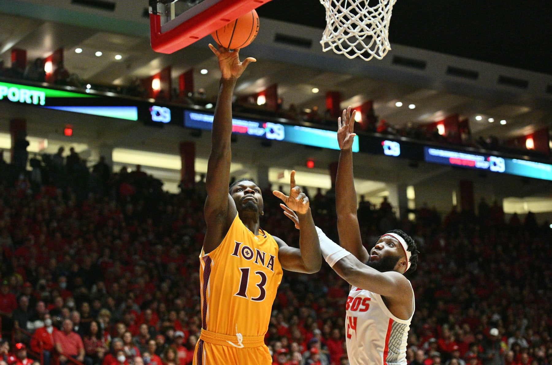 ALBUQUERQUE, NEW MEXICO - DECEMBER 18: Nelly Junior Joseph #13 of the Iona Gaels shoots against Morris Udeze #24 of the New Mexico Lobos during the first half of their game at The Pit on December 18, 2022 in Albuquerque, New Mexico. (Photo by Sam Wasson/Getty Images)