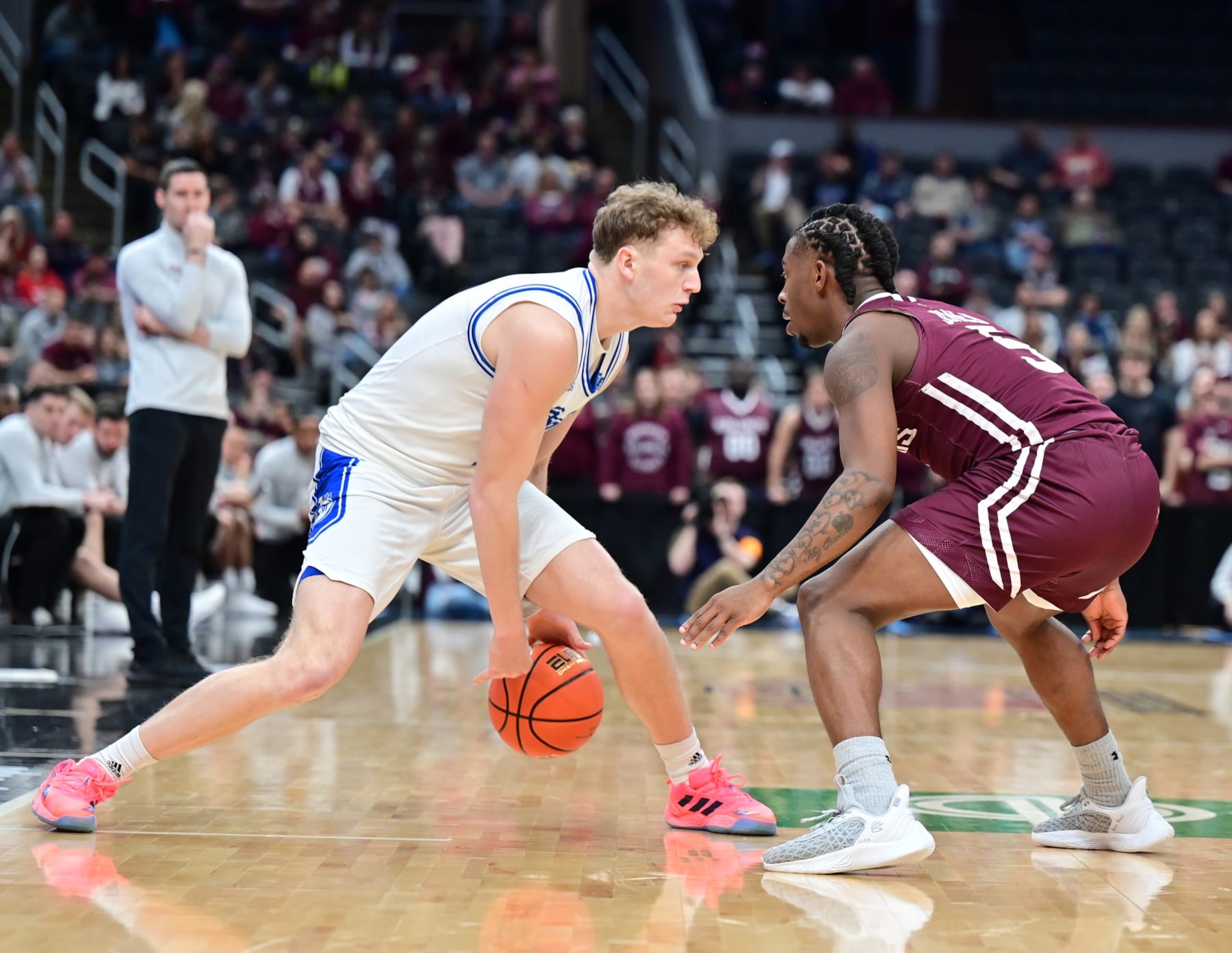 ST. LOUIS, MO - MARCH 04: Drake guard Tucker DeVries (12) drives to the basket as Southern Illinois guard Lance Jones (5) defends during a college basketball game between the Drake Bulldogs and the Southern Illinois Salukis in the semi-finals of the Missouri Valley Basketball Tournament on March 04, 2023, at Enterprise Center in St. Louis, MO (Photo by Keith Gillett/Icon Sportswire via Getty Images)