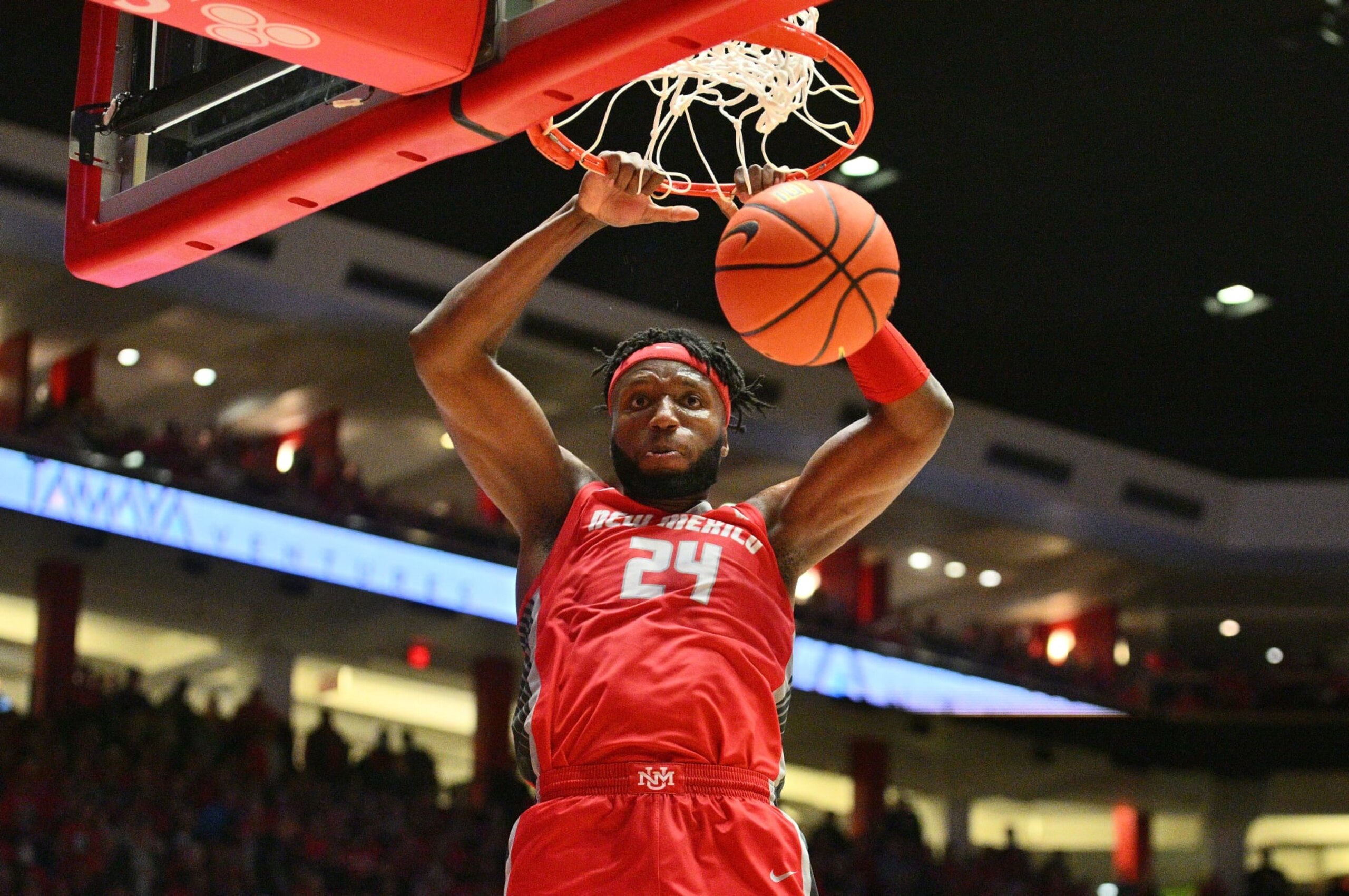 ALBUQUERQUE, NEW MEXICO - FEBRUARY 07: Morris Udeze #24 of the New Mexico Lobos dunks against the Nevada Wolf Pack during the second half of their game at The Pit on February 07, 2023 in Albuquerque, New Mexico. The Wolf Pack defeated the Lobos 77-76. (Photo by Sam Wasson/Getty Images)