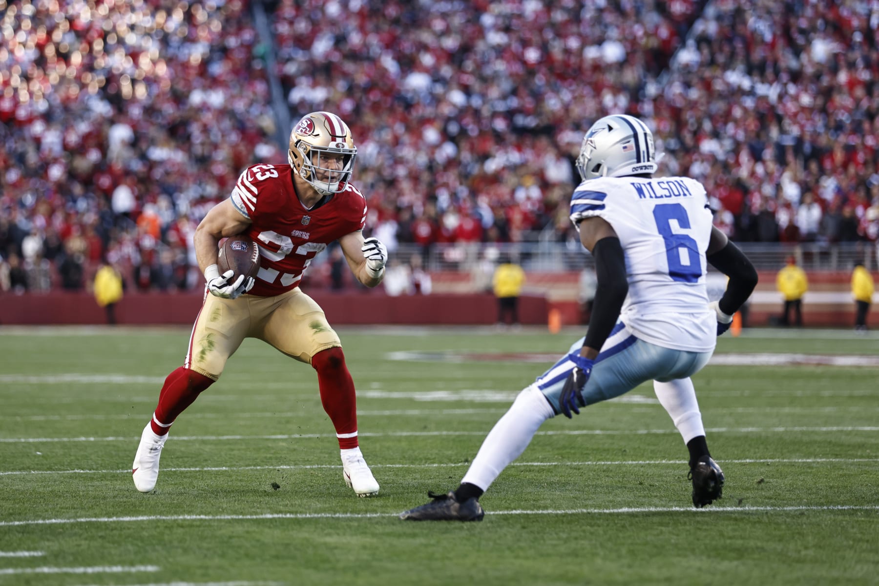 SANTA CLARA, CALIFORNIA - JANUARY 22: Christian McCaffrey #23 of the San Francisco 49ers runs with the ball against Donovan Wilson #6 of the Dallas Cowboys during an NFL divisional round playoff football game between the San Francisco 49ers and the Dallas Cowboys at Levi's Stadium on January 22, 2023 in Santa Clara, California. (Photo by Michael Owens/Getty Images)
