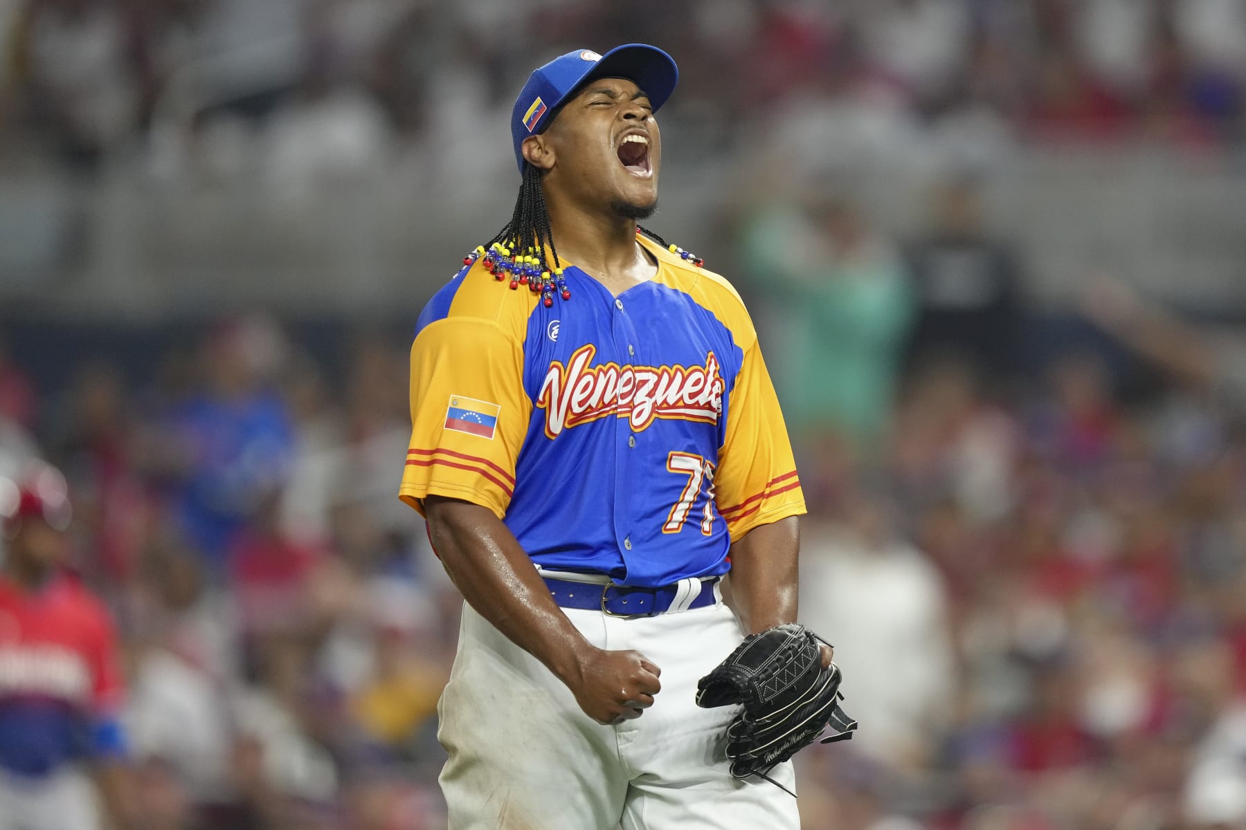 MIAMI, FLORIDA - MARCH 11: Luis Garcia #77 of Venezuela reacts after striking out Teoscar Hernandez #37 of the Dominican Republic during the seventh inning at loanDepot park on March 11, 2023 in Miami, Florida. (Photo by Eric Espada/Getty Images)
