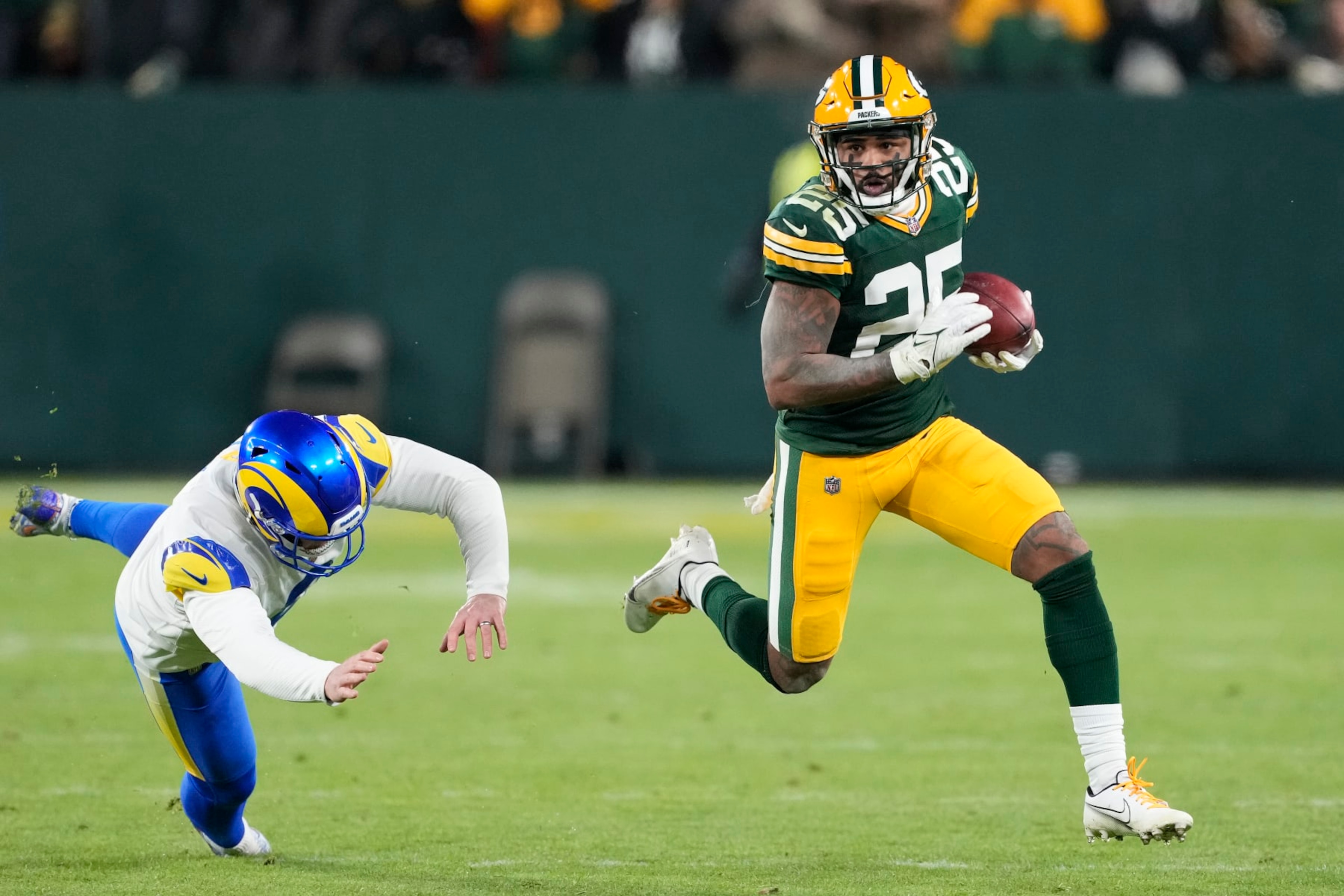 GREEN BAY, WISCONSIN - DECEMBER 19: Keisean Nixon #25 of the Green Bay Packers runs with the ball in the first half against the Los Angeles Rams at Lambeau Field on December 19, 2022 in Green Bay, Wisconsin. (Photo by Patrick McDermott/Getty Images)