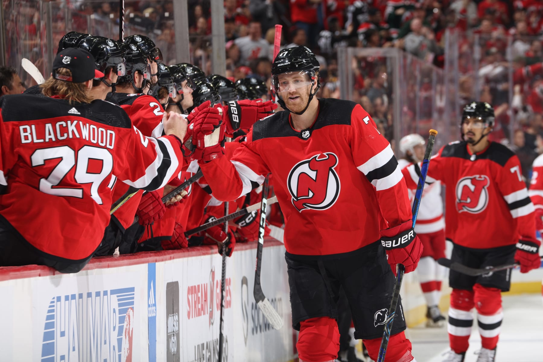 NEWARK, NEW JERSEY - OCTOBER 15:  Dougie Hamilton #7 of the New Jersey Devils celebrates with teammates after scoring a goal in the first period against the Detroit Red Wings at the Prudential Center during the home opener on October 15, 2022 in Newark, New Jersey. (Photo by Jared Silber/Getty Images)