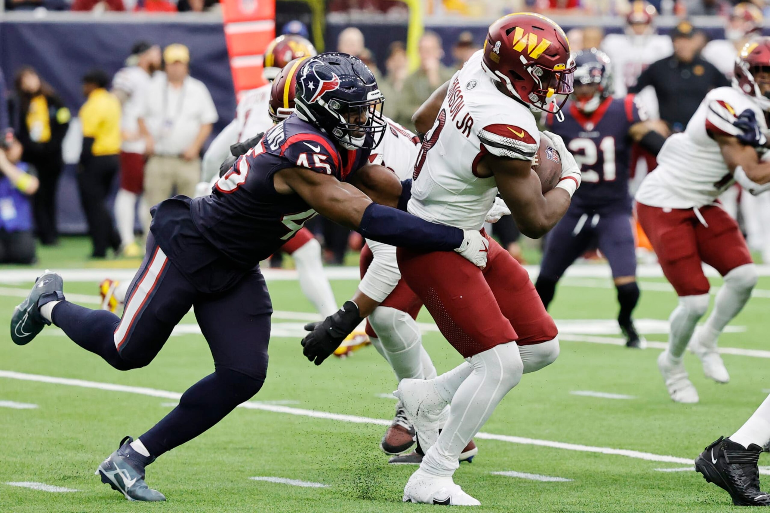 HOUSTON, TEXAS - NOVEMBER 20: Brian Robinson Jr. #8 of the Washington Commanders gets tackled by Ogbonnia Okoronkwo #45 of the Houston Texans in the fourth quarter at NRG Stadium on November 20, 2022 in Houston, Texas. (Photo by Bob Levey/Getty Images) HOUSTON, TEXAS - NOVEMBER 20: Brian Robinson Jr. #8 of the Washington Commanders gets tackled by Ogbonnia Okoronkwo #45 of the Houston Texans in the fourth quarter at NRG Stadium on November 20, 2022 in Houston, Texas. (Photo by Bob Levey/Getty Images)