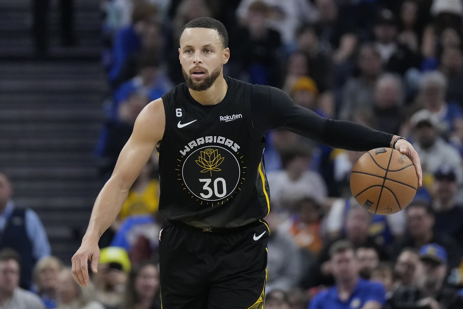 Golden State Warriors guard Stephen Curry (30) brings the ball up the court against the Milwaukee Bucks during the first half of an NBA basketball game in San Francisco, Saturday, March 11, 2023. (AP Photo/Jeff Chiu)