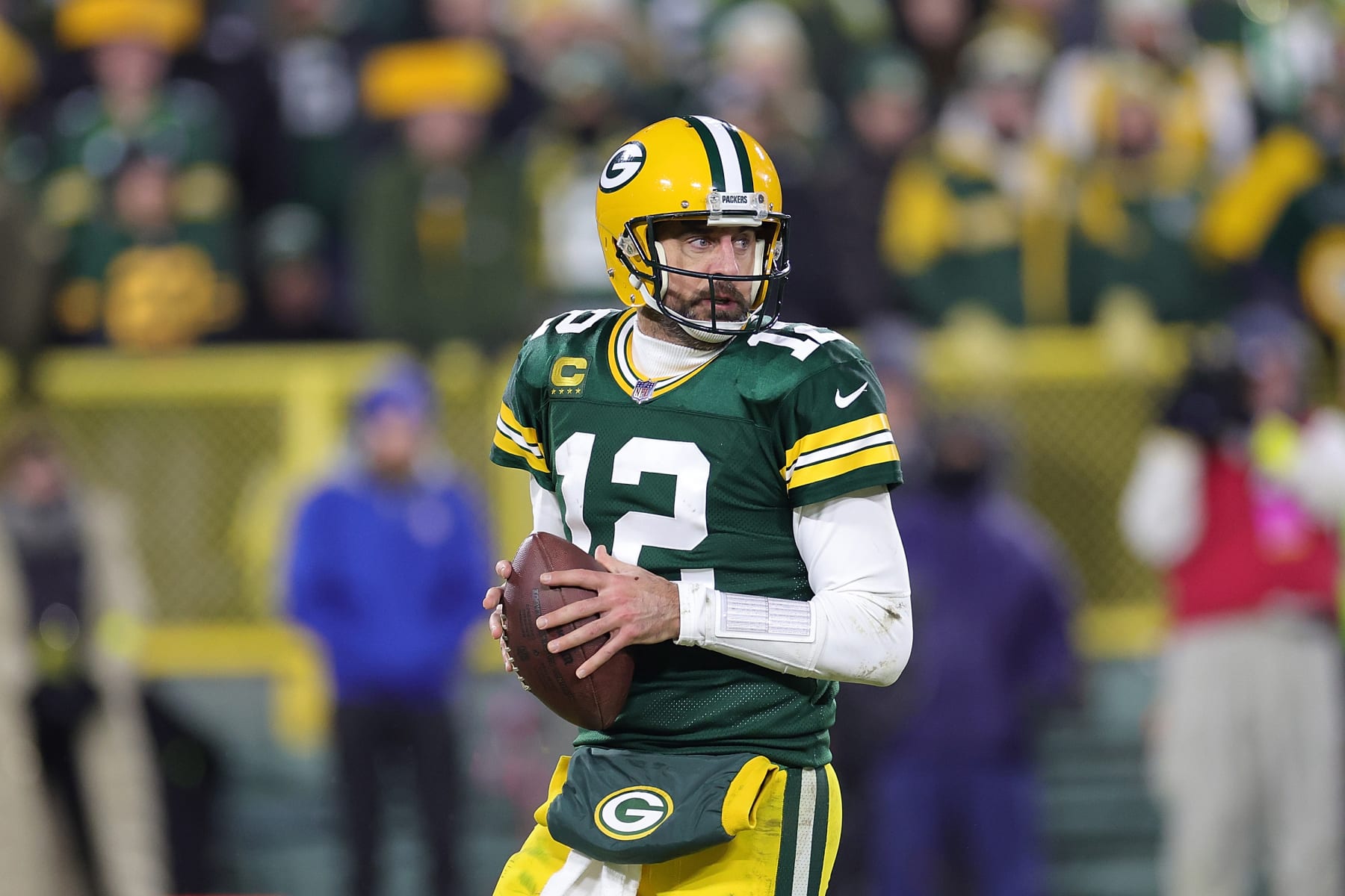 GREEN BAY, WISCONSIN - JANUARY 08: Aaron Rodgers #12 of the Green Bay Packers drops back to pass during a game against the Detroit Lions at Lambeau Field on January 08, 2023 in Green Bay, Wisconsin. The Lions defeated the Packers 20-16. (Photo by Stacy Revere/Getty Images)