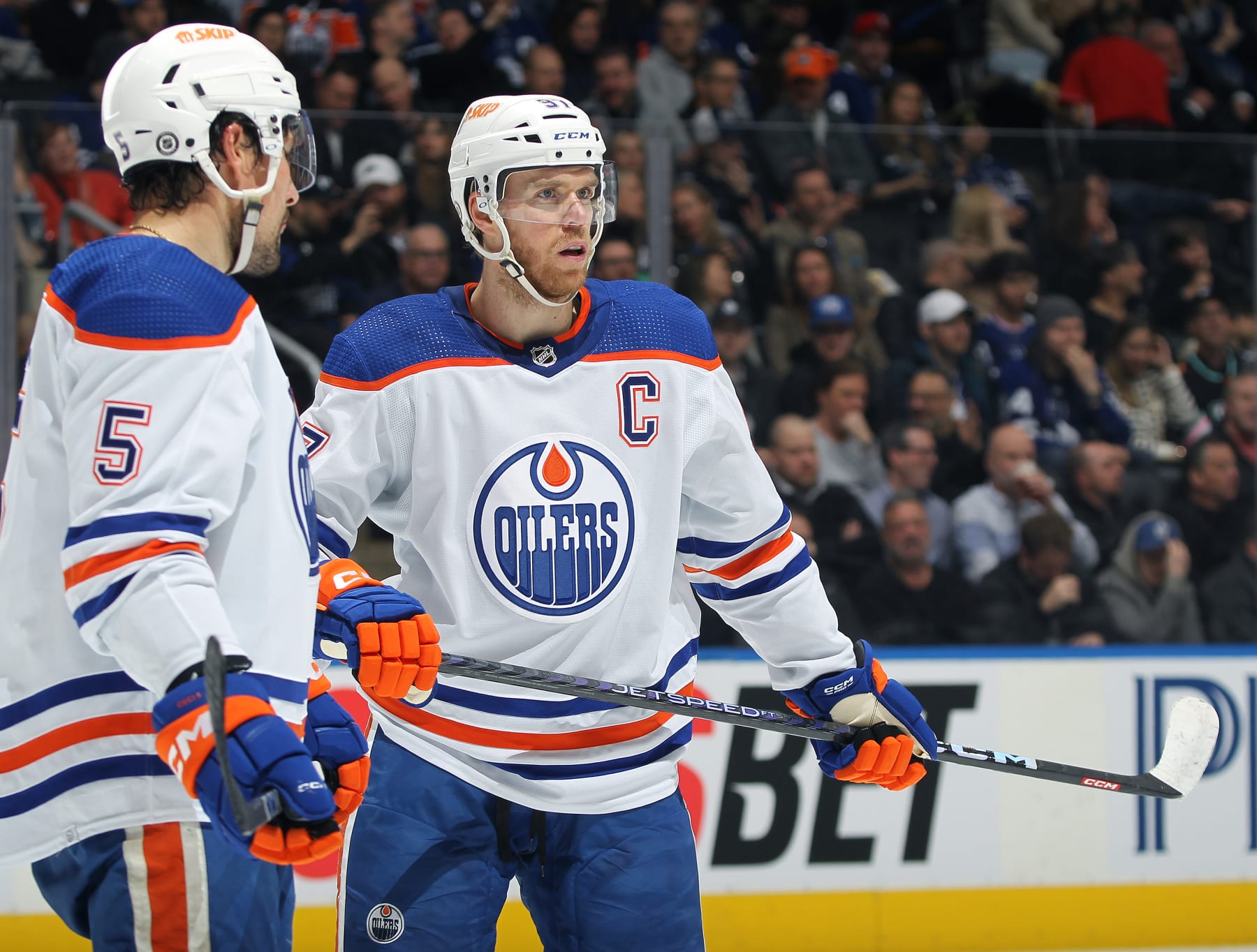 TORONTO, CANADA - MARCH 11:  Connor McDavid #97 and Cody Ceci #5 of the Edmonton Oilers wait for play to resume against the Toronto Maple Leafs in an NHL game at Scotiabank Arena on March 11, 2023 in Toronto, Ontario, Canada. The Maple Leafs defeated the Oilers 7-4. (Photo by Claus Andersen/Getty Images)