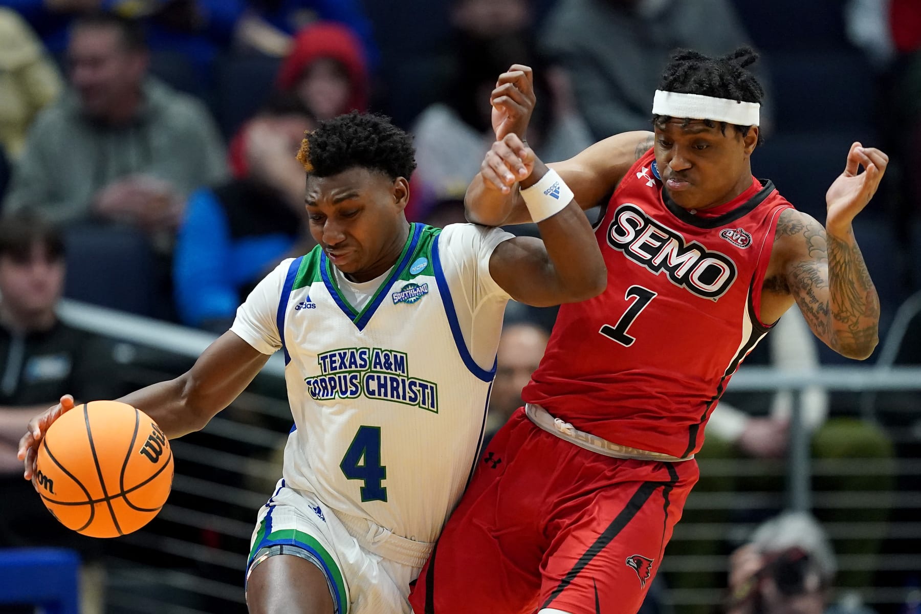 DAYTON, OHIO - MARCH 14: Jalen Jackson #4 of the Texas A&M-CC Islanders collides with Phillip Russell #1 of the Southeast Missouri State Redhawks during the first half in the First Four of the NCAA Men's Basketball Tournament at University of Dayton Arena on March 14, 2023 in Dayton, Ohio. (Photo by Dylan Buell/Getty Images)