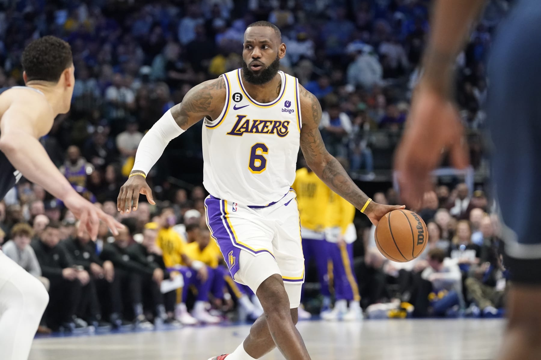 Los Angeles Lakers forward LeBron James (6) dribbles against Dallas Mavericks center Dwight Powell during the first quarter of an NBA basketball game in Dallas, Sunday, Feb. 26, 2023. (AP Photo/LM Otero)