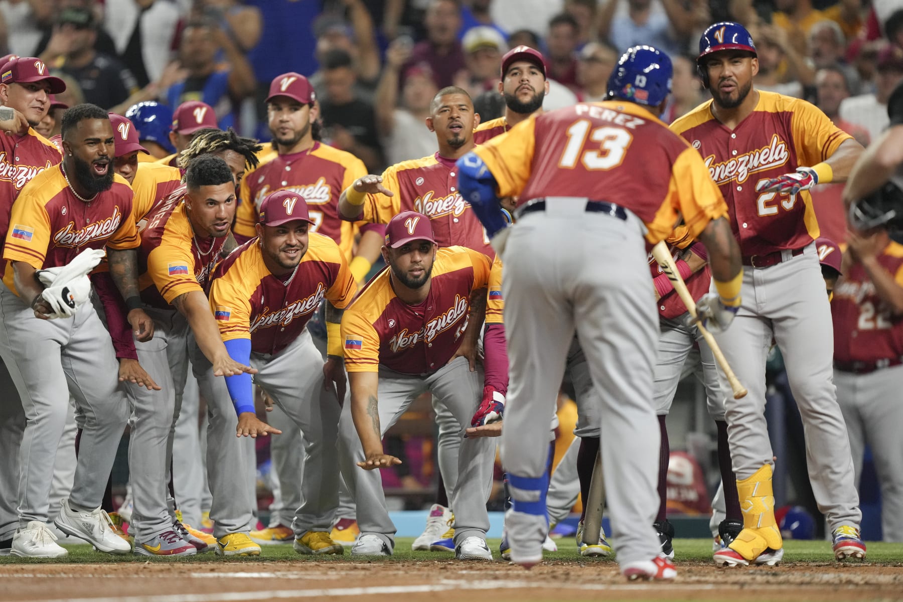 MIAMI, FLORIDA - MARCH 12: Salvador Perez #13 of Venezuela celebrates with teammates after hitting a home run in the second inning against Puerto Rico at loanDepot park on March 12, 2023 in Miami, Florida. (Photo by Eric Espada/Getty Images)