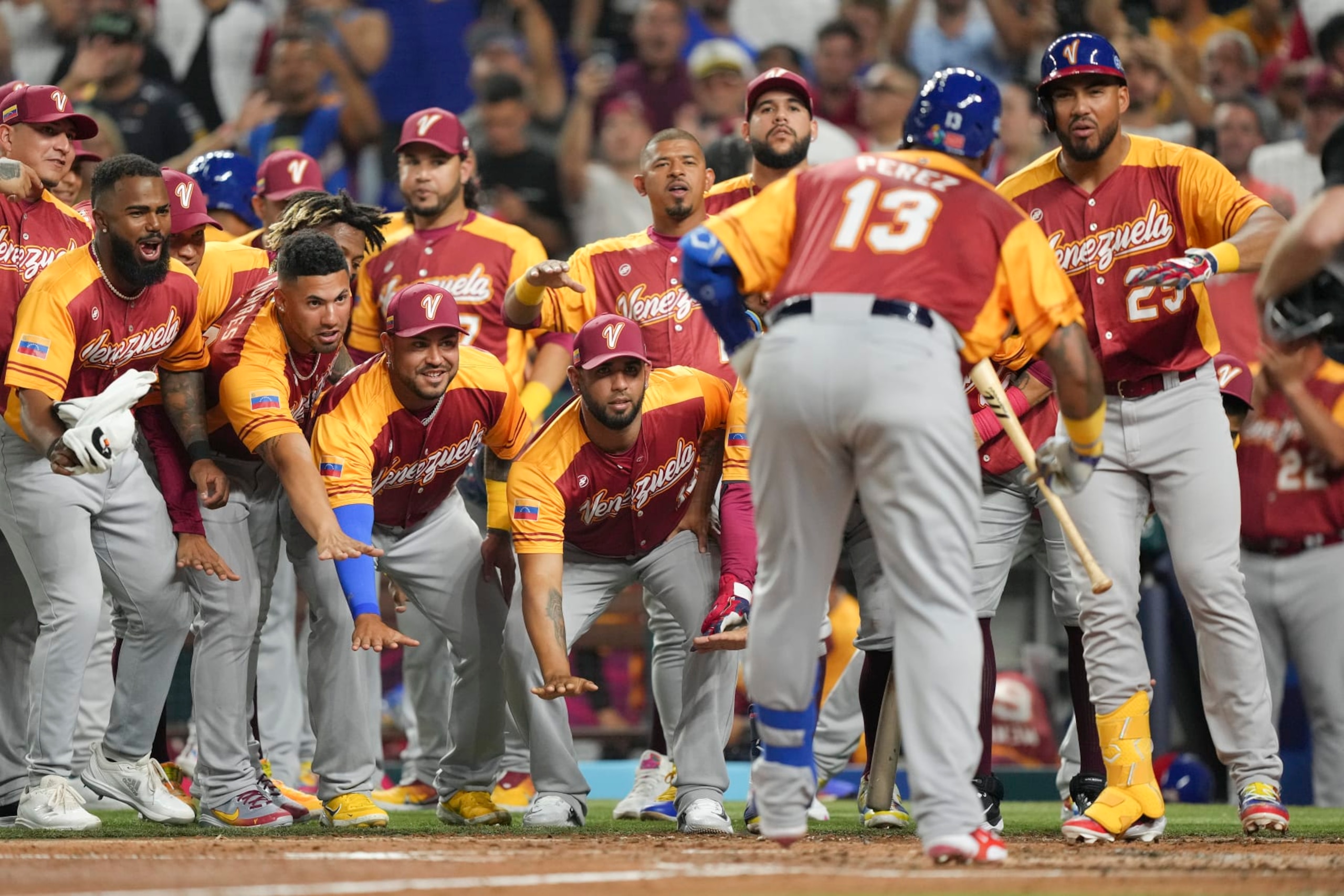MIAMI, FLORIDA - MARCH 12: Salvador Perez #13 of Venezuela celebrates with teammates after hitting a home run in the second inning against Puerto Rico at loanDepot park on March 12, 2023 in Miami, Florida. (Photo by Eric Espada/Getty Images)