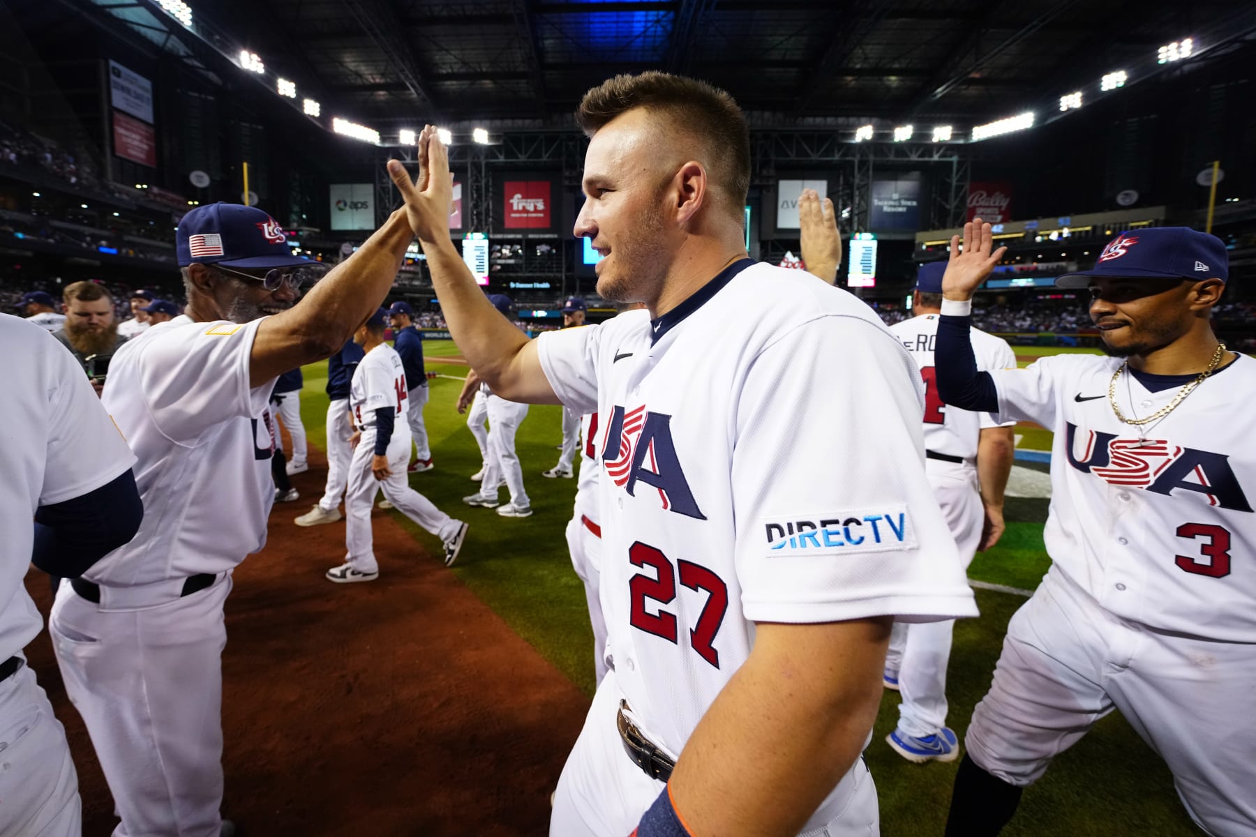 PHOENIX, AZ - MARCH 13:  Third Base Coach Dino Ebel #14 and Mike Trout #27 of Team USA celebrate after Team USA defeated Team Canada in Game 6 of Pool C at Chase Field on Monday, March 13, 2023 in Phoenix, Arizona. (Photo by Daniel Shirey/WBCI/MLB Photos via Getty Images)