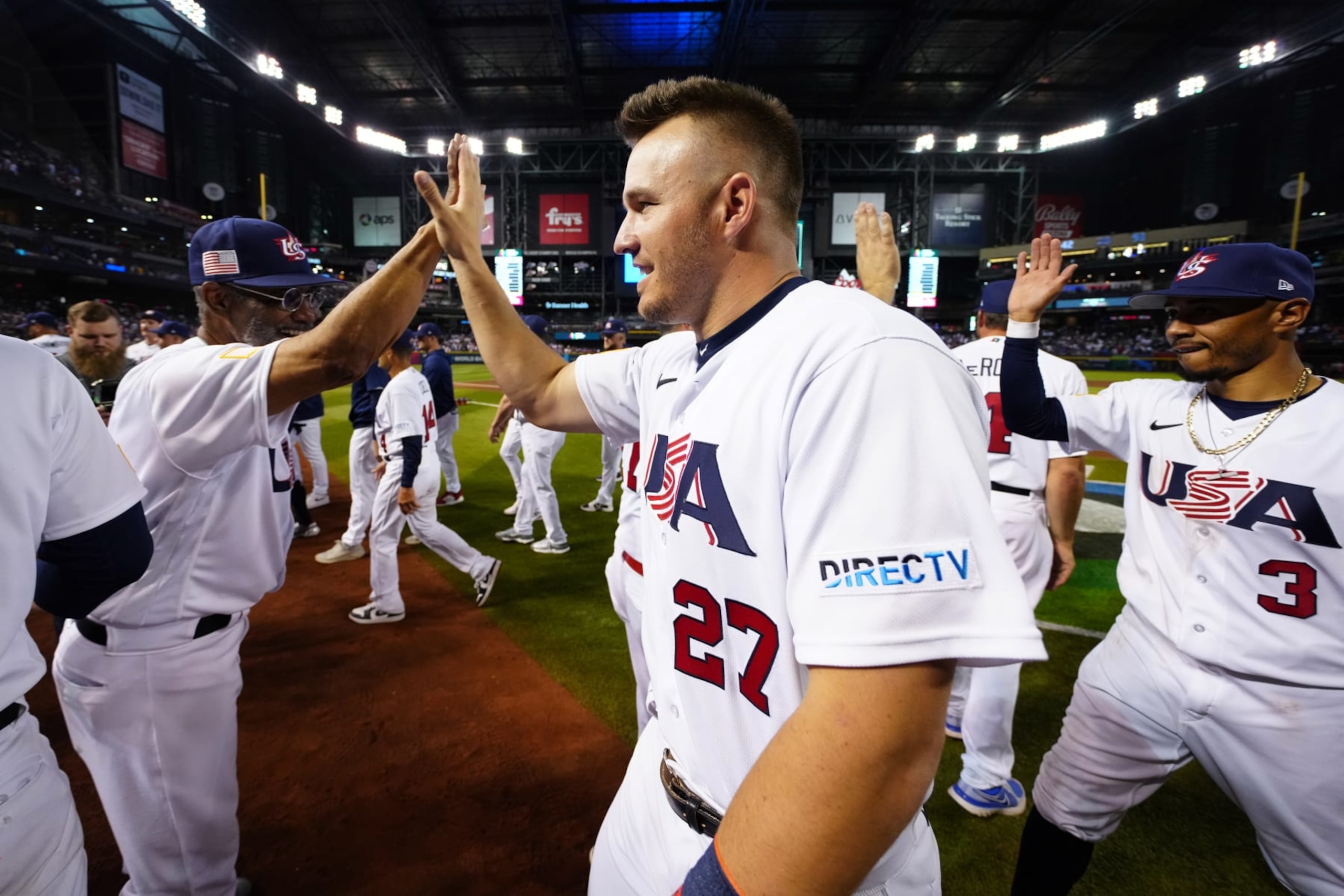 PHOENIX, AZ - MARCH 13:  Third Base Coach Dino Ebel #14 and Mike Trout #27 of Team USA celebrate after Team USA defeated Team Canada in Game 6 of Pool C at Chase Field on Monday, March 13, 2023 in Phoenix, Arizona. (Photo by Daniel Shirey/WBCI/MLB Photos via Getty Images)