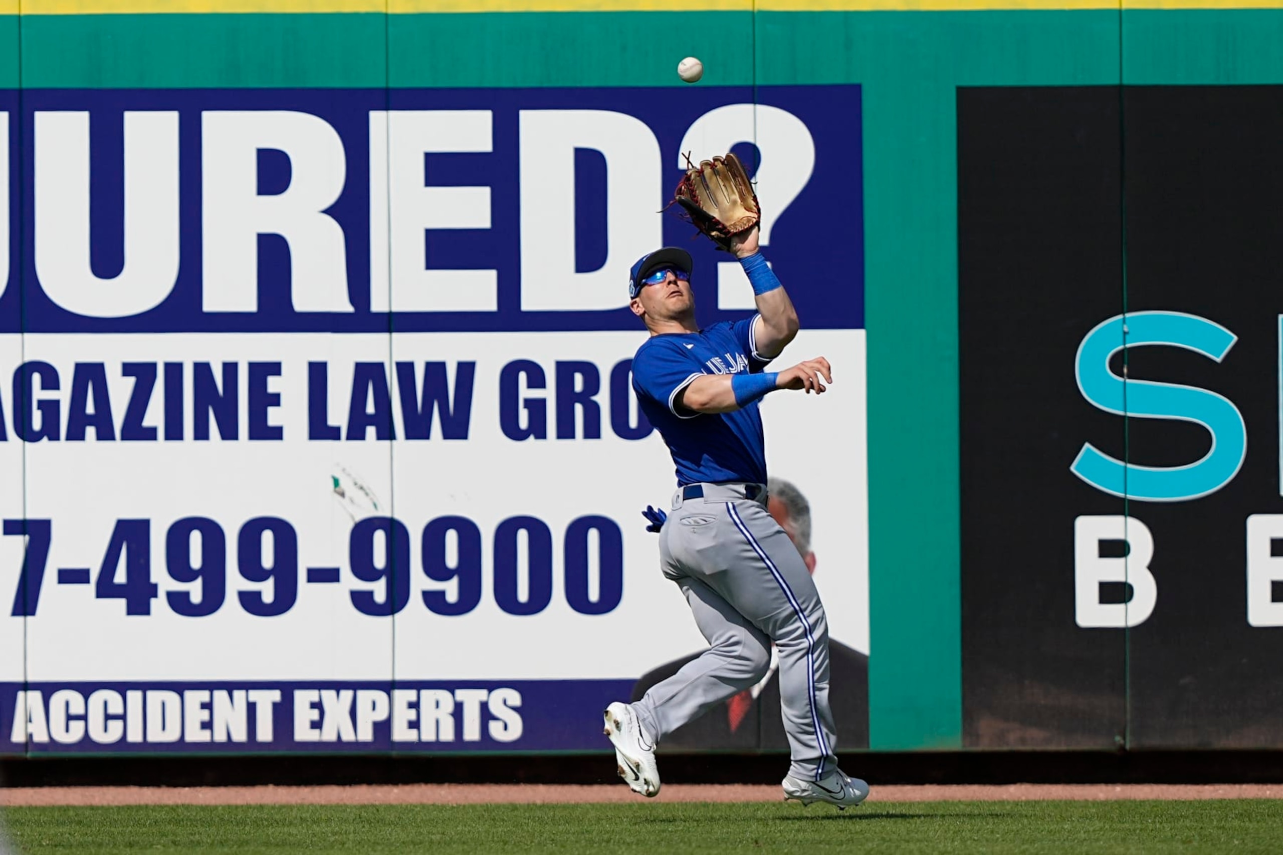 Toronto Blue Jays outfielder Daulton Varsho catches a fly ball by Philadelphia Phillies' Bryson Stott during the fourth inning of a spring training baseball game Tuesday, Feb. 28, 2023, in Clearwater, Fla. (AP Photo/David J. Phillip)