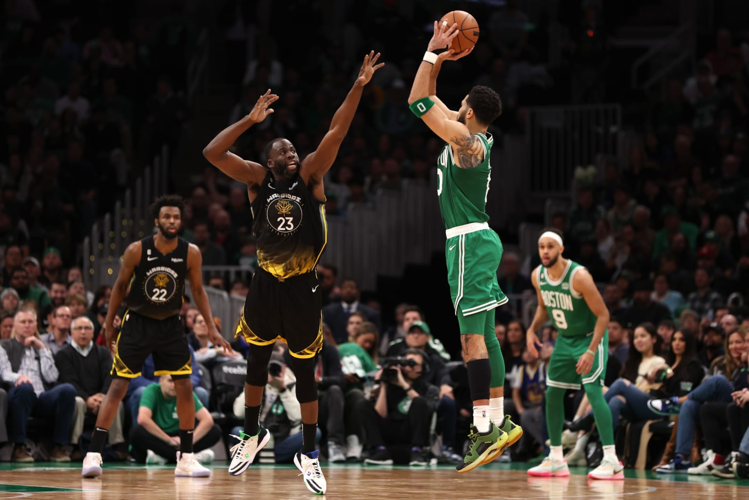 BOSTON, MASSACHUSETTS - JANUARY 19: Jayson Tatum #0 of the Boston Celtics takes a shot against Draymond Green #23 of the Golden State Warriors during the second half at TD Garden on January 19, 2023 in Boston, Massachusetts. The Celtics defeat the Warriors 121-118. NOTE TO USER: User expressly acknowledges and agrees that, by downloading and or using this photograph, User is consenting to the terms and conditions of the Getty Images License Agreement. (Photo by Maddie Meyer/Getty Images)