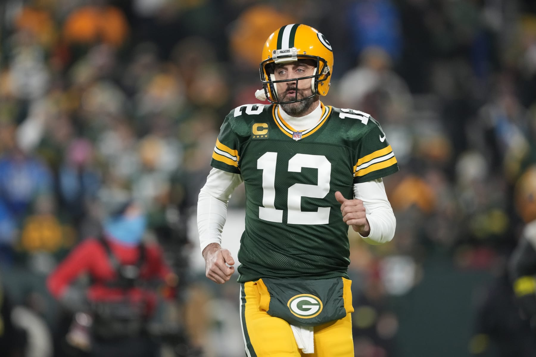 GREEN BAY, WISCONSIN - JANUARY 08: Aaron Rodgers #12 of the Green Bay Packers warms up prior to the game against the Detroit Lions at Lambeau Field on January 08, 2023 in Green Bay, Wisconsin. (Photo by Patrick McDermott/Getty Images)