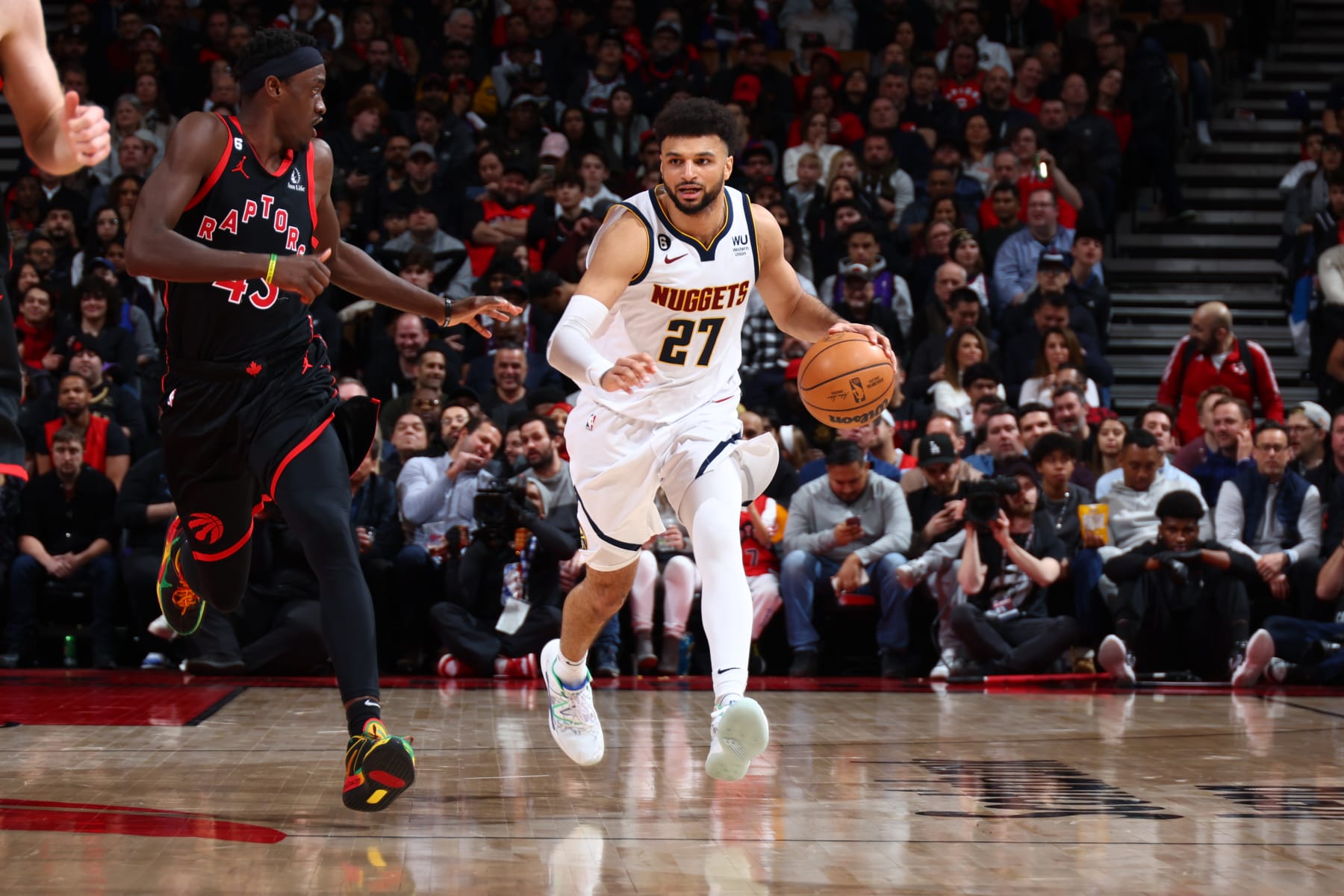 TORONTO, CANADA - MARCH 14: Jamal Murray #27 of the Denver Nuggets dribbles the ball during the game against the Toronto Raptors on March 14, 2023 at the Scotiabank Arena in Toronto, Ontario, Canada.  NOTE TO USER: User expressly acknowledges and agrees that, by downloading and or using this Photograph, user is consenting to the terms and conditions of the Getty Images License Agreement.  Mandatory Copyright Notice: Copyright 2023 NBAE (Photo by Vaughn Ridley/NBAE via Getty Images)