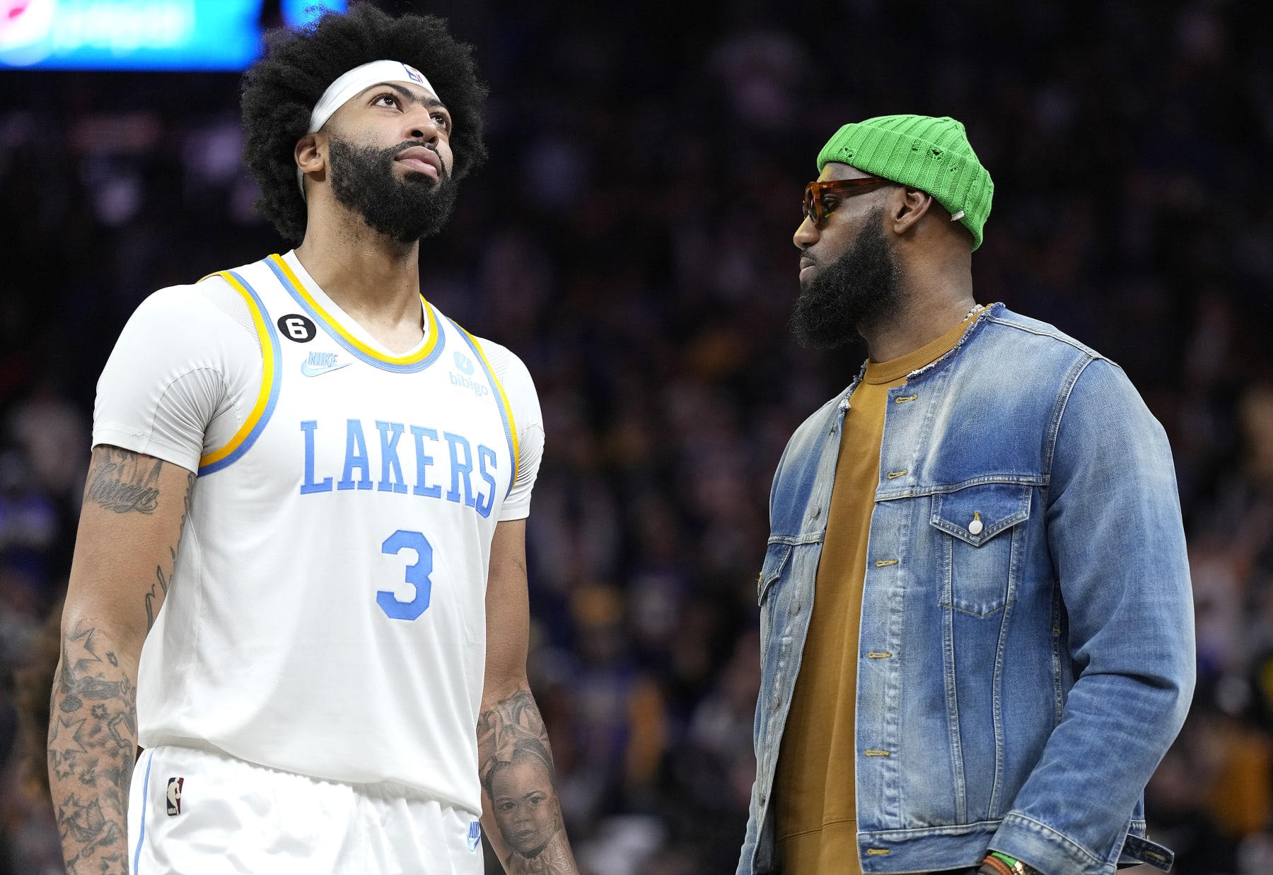 SAN FRANCISCO, CALIFORNIA - FEBRUARY 11: Anthony Davis #3 of the Los Angeles Lakers talks with injured LeBron James #6 during a time out against the Golden State Warriors in the fourth quarter of an NBA basketball game at Chase Center on February 11, 2023 in San Francisco, California. NOTE TO USER: User expressly acknowledges and agrees that, by downloading and or using this photograph, User is consenting to the terms and conditions of the Getty Images License Agreement. (Photo by Thearon W. Henderson/Getty Images)