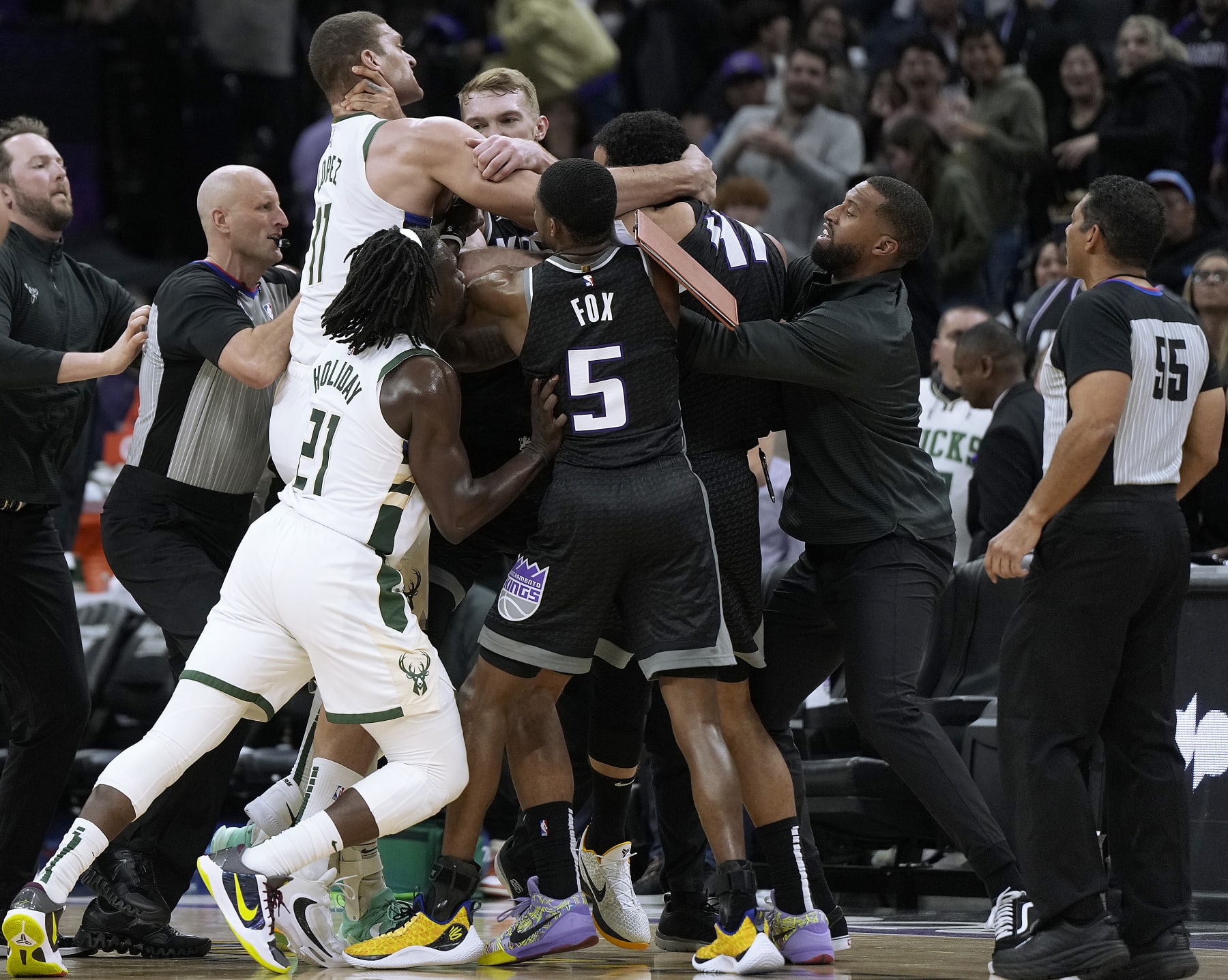 SACRAMENTO, CALIFORNIA - MARCH 13: Brook Lopez #11 of the Milwaukee Bucks and Trey Lyles #41 of the Sacramento Kings gets tangled up in a fight while teammates Jrue Holiday #21 of the Bucks and De'Aaron Fox #5 of the Kings attempt to come in between them late in fourth quarter at Golden 1 Center on March 13, 2023 in Sacramento, California. NOTE TO USER: User expressly acknowledges and agrees that, by downloading and or using this photograph, User is consenting to the terms and conditions of the Getty Images License Agreement. (Photo by Thearon W. Henderson/Getty Images)