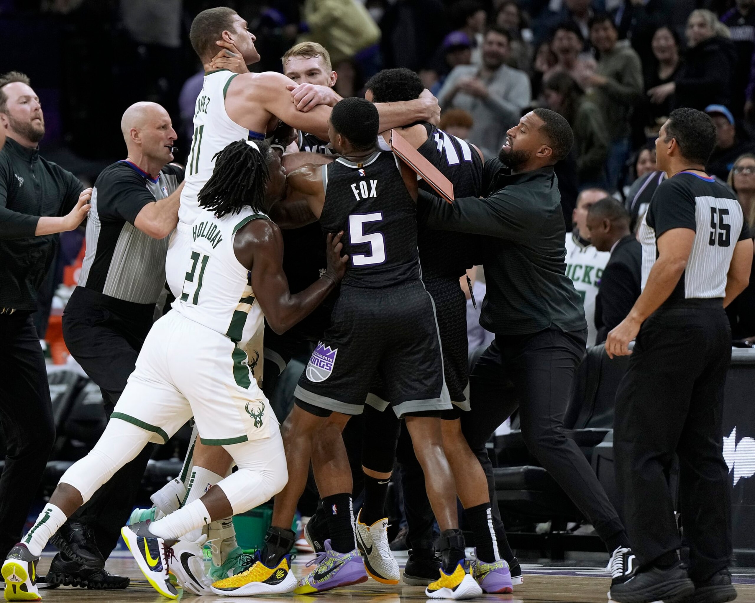 SACRAMENTO, CALIFORNIA - MARCH 13: Brook Lopez #11 of the Milwaukee Bucks and Trey Lyles #41 of the Sacramento Kings gets tangled up in a fight while teammates Jrue Holiday #21 of the Bucks and De'Aaron Fox #5 of the Kings attempt to come in between them late in fourth quarter at Golden 1 Center on March 13, 2023 in Sacramento, California. NOTE TO USER: User expressly acknowledges and agrees that, by downloading and or using this photograph, User is consenting to the terms and conditions of the Getty Images License Agreement. (Photo by Thearon W. Henderson/Getty Images)