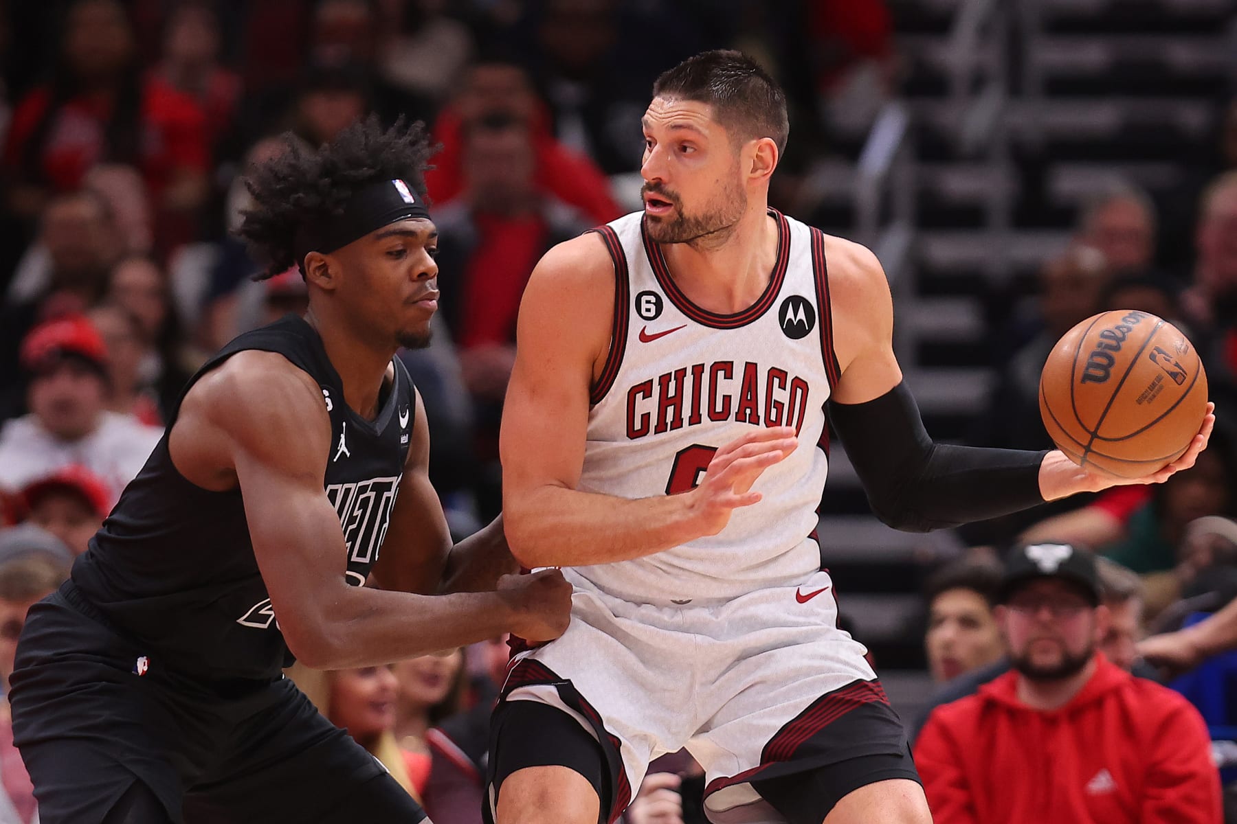 CHICAGO, ILLINOIS - FEBRUARY 24: Nikola Vucevic #9 of the Chicago Bulls is defended by Day'Ron Sharpe #20 of the Brooklyn Nets during the first half at United Center on February 24, 2023 in Chicago, Illinois. NOTE TO USER: User expressly acknowledges and agrees that, by downloading and or using this photograph, User is consenting to the terms and conditions of the Getty Images License Agreement.  (Photo by Michael Reaves/Getty Images)