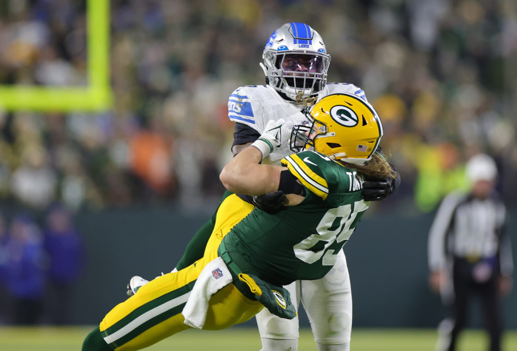 GREEN BAY, WISCONSIN - JANUARY 08: Robert Tonyan #85 of the Green Bay Packers catches a pass defended by DeShon Elliott #5 of the Detroit Lions during the first half at Lambeau Field on January 08, 2023 in Green Bay, Wisconsin. (Photo by Stacy Revere/Getty Images)