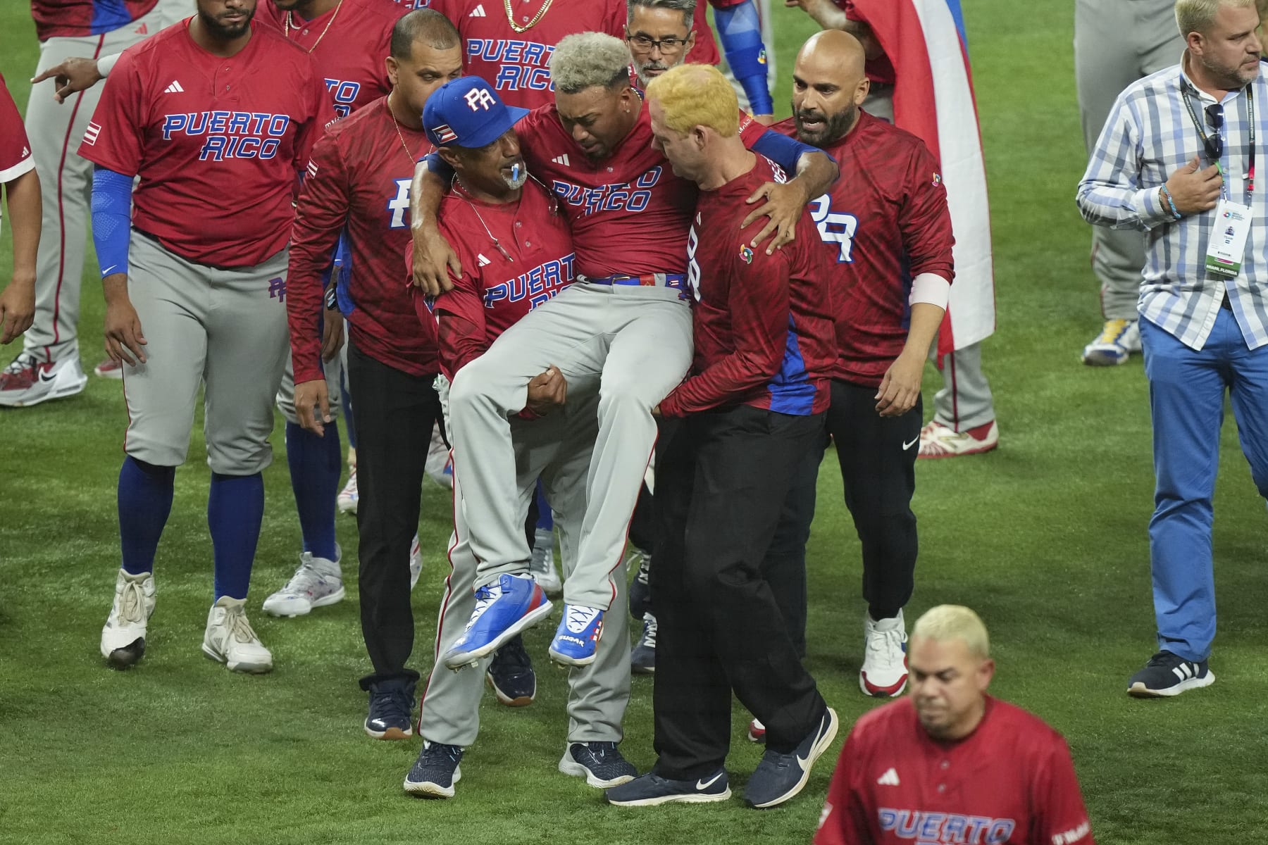 MIAMI, FLORIDA - MARCH 15: Edwin Diaz #39 of Puerto Rico is helped off the field after being injured during the on-field celebration after defeating the Dominican Republic during the World Baseball Classic Pool D at loanDepot park on March 15, 2023 in Miami, Florida. (Photo by Eric Espada/Getty Images)