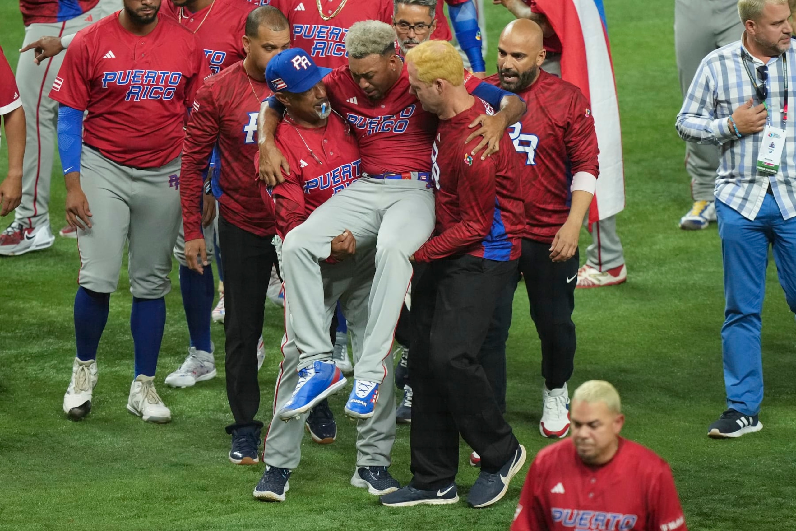 MIAMI, FLORIDA - MARCH 15: Edwin Diaz #39 of Puerto Rico is helped off the field after being injured during the on-field celebration after defeating the Dominican Republic during the World Baseball Classic Pool D at loanDepot park on March 15, 2023 in Miami, Florida. (Photo by Eric Espada/Getty Images)