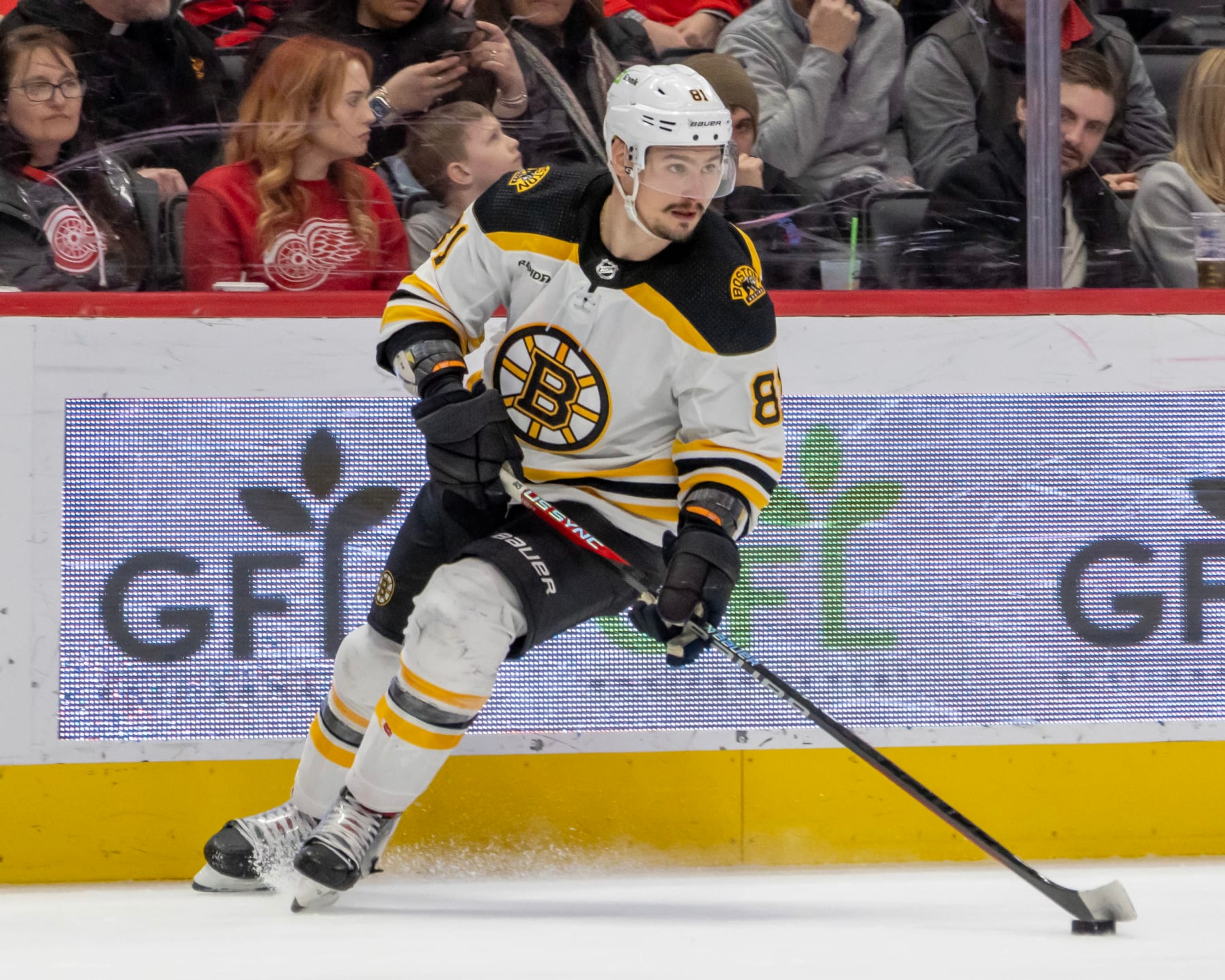 DETROIT, MI - MARCH 12: Dmitry Orlov #81 of the Boston Bruins turns up ice with the puck against the Detroit Red Wings during the third period of an NHL game at Little Caesars Arena on March 12, 2023 in Detroit, Michigan. Detroit defeated Boston 5-3. (Photo by Dave Reginek/NHLI via Getty Images)