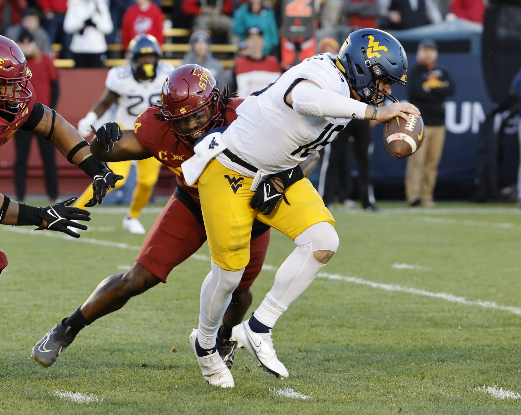 AMES, IA - NOVEMBER 5: Linebacker O'Rien Vance #34 of the Iowa State Cyclones sacks quarterback JT Daniels #18 of the West Virginia Mountaineers as he scrambles for yards in the second half of play at Jack Trice Stadium on November 5, 2022 in Ames, Iowa. The Iowa State Cyclones won 31-14 over the West Virginia Mountaineers. (Photo by David Purdy/Getty Images)