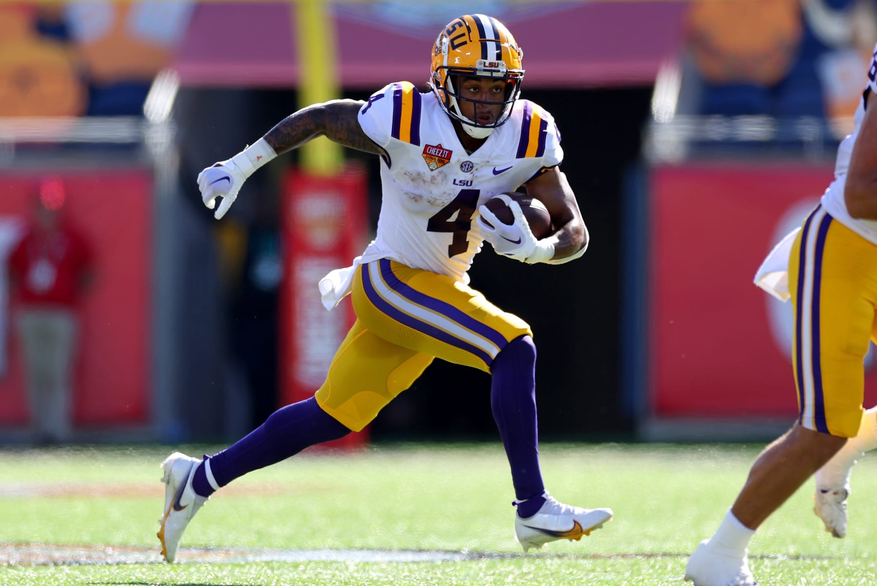 ORLANDO, FLORIDA - JANUARY 02: John Emery Jr. #4 of the LSU Tigers rushes during the Cheez-It Citrus Bowl against the Purdue Boilermakers at Camping World Stadium on January 02, 2023 in Orlando, Florida. (Photo by Mike Ehrmann/Getty Images)