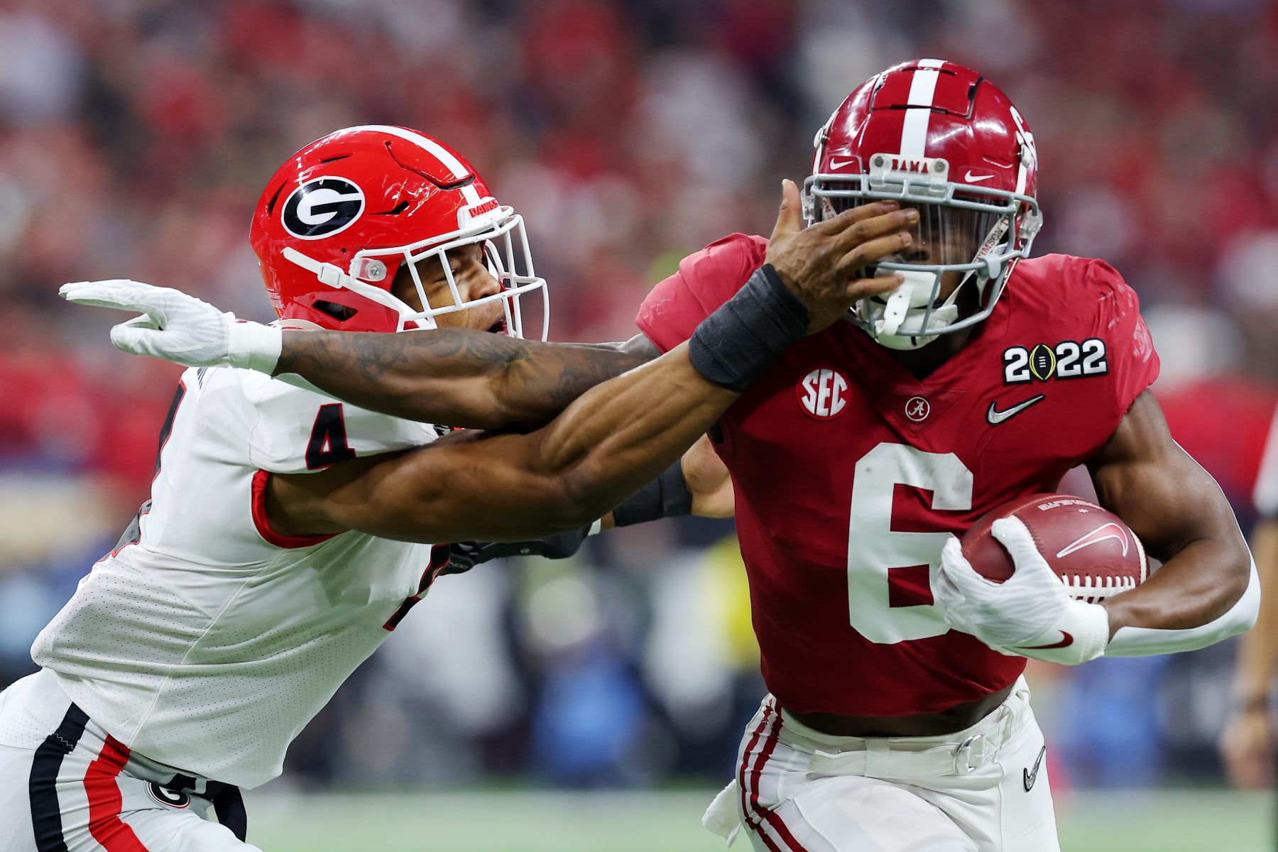 INDIANAPOLIS, INDIANA - JANUARY 10: Trey Sanders #6 of the Alabama Crimson Tide runs with the ball as Nolan Smith #4 of the Georgia Bulldogs defends in the first quarter of the game in the 2022 CFP National Championship Game at Lucas Oil Stadium on January 10, 2022 in Indianapolis, Indiana. (Photo by Kevin C. Cox/Getty Images)