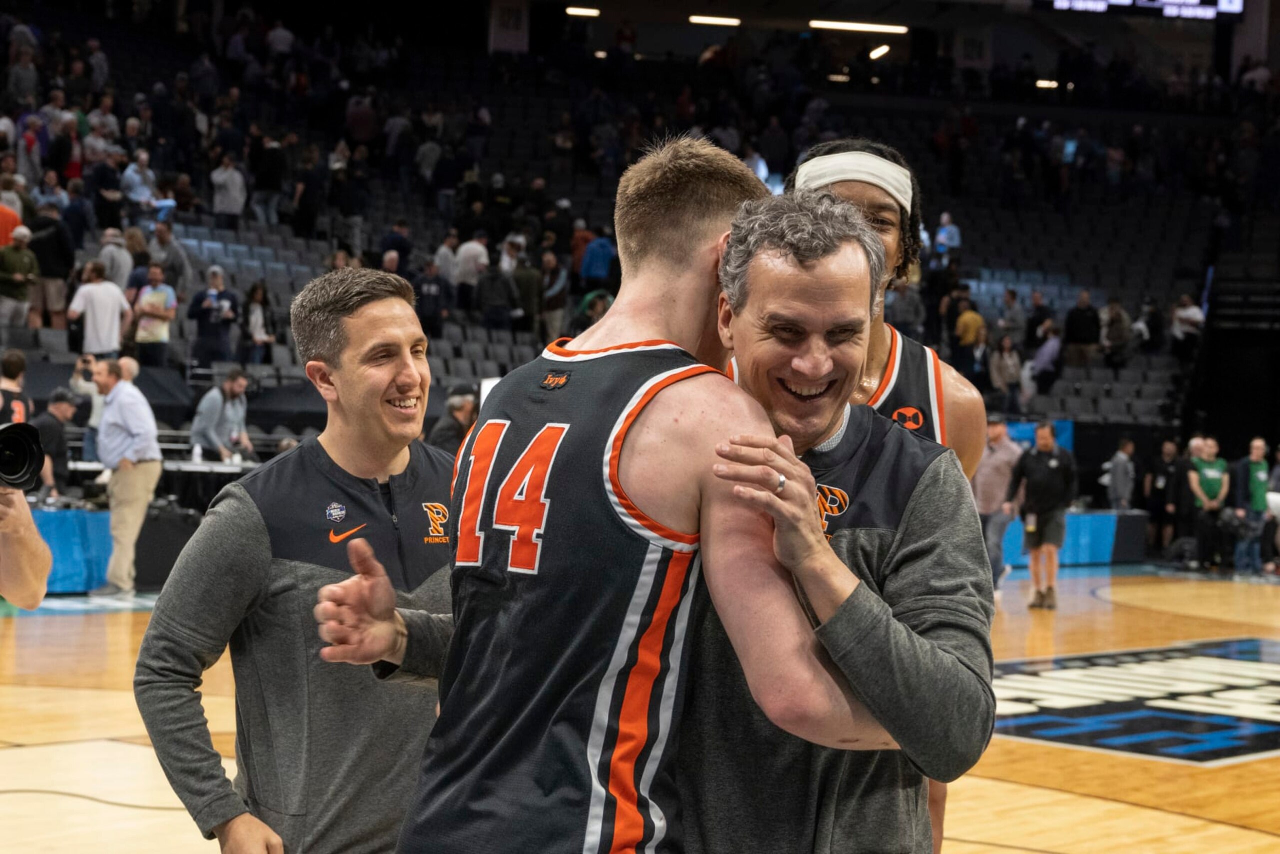 Princeton head coach Mitch Henderson embraces guard Matt Allocco (14) after their first-round college basketball game victory over Arizona in the NCAA Tournament in Sacramento, Calif., Thursday, March 16, 2023. Princeton won 59-55. (AP Photo/José Luis Villegas)