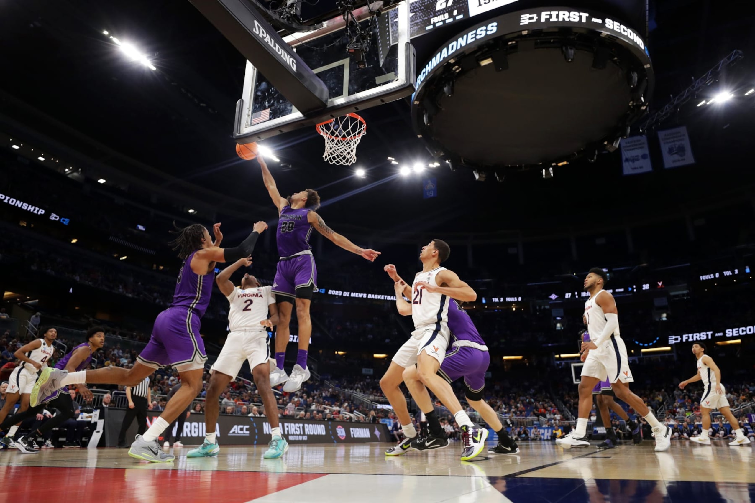 ORLANDO, FLORIDA - MARCH 16: Jalen Slawson #20 of the Furman Paladins blocks Reece Beekman #2 of the Virginia Cavaliers  during the second half in the first round of the NCAA Men's Basketball Tournament at Amway Center on March 16, 2023 in Orlando, Florida. (Photo by Mike Ehrmann/Getty Images)