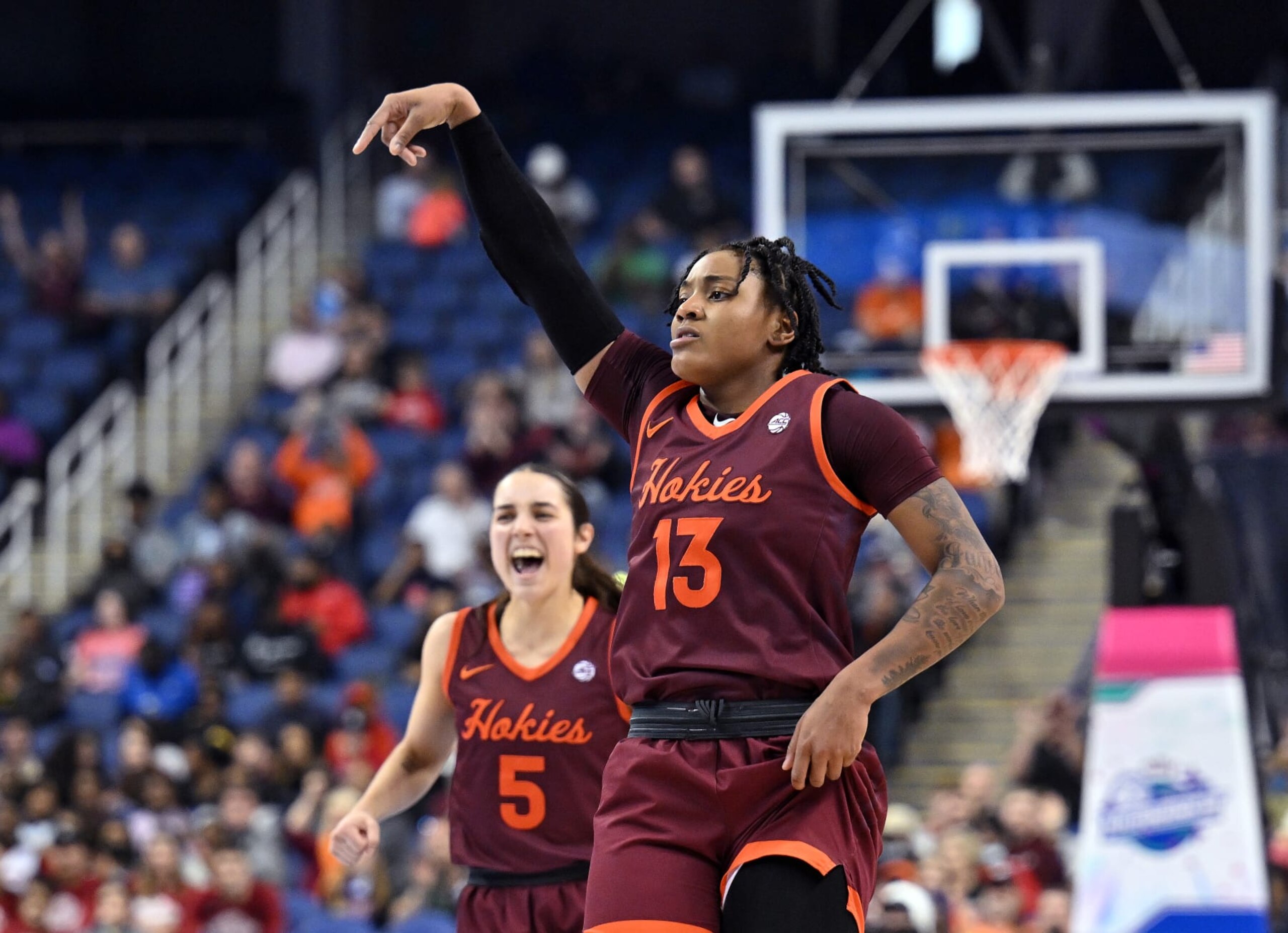 GREENSBORO, NORTH CAROLINA - MARCH 05: Taylor Soule #13 and Georgia Amoore #5 of the Virginia Tech Hokies reacts after a three-point basket by Soule against the Louisville Cardinals during the second half of the ACC Women's Basketball Tournament Championship game at Greensboro Coliseum on March 05, 2023 in Greensboro, North Carolina. Virginia Tech won 75-67. (Photo by Grant Halverson/Getty Images)