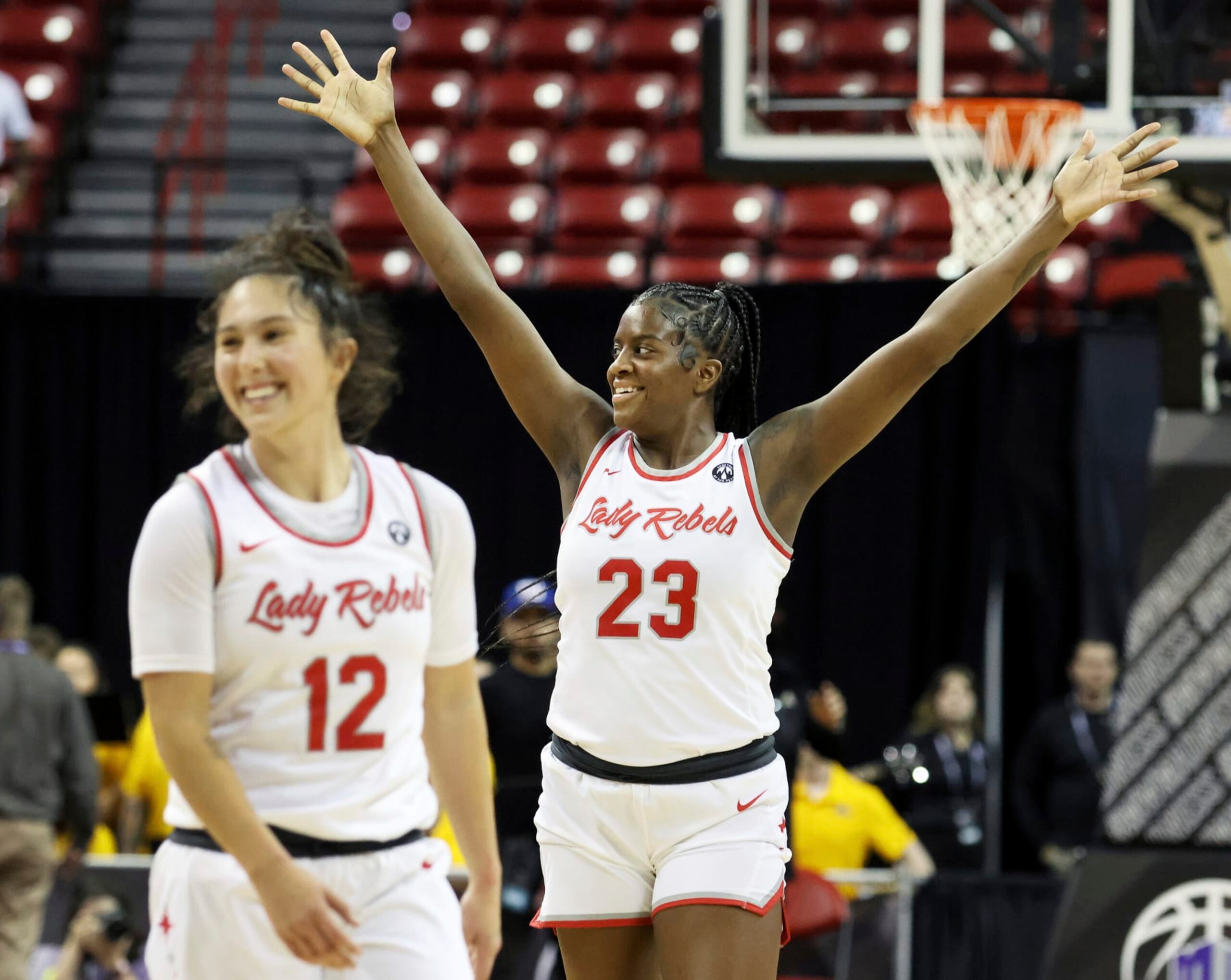 UNLV's Desi-Rae Young (23) and Alyssa Durazo-Frescas (12) celebrate their team's win against Wyoming in the final seconds of play at the NCAA college basketball Mountain West tournament championship Wednesday, March 8, 2023, in Las Vegas. UNLV won 71-60. (AP Photo/Ronda Churchill)