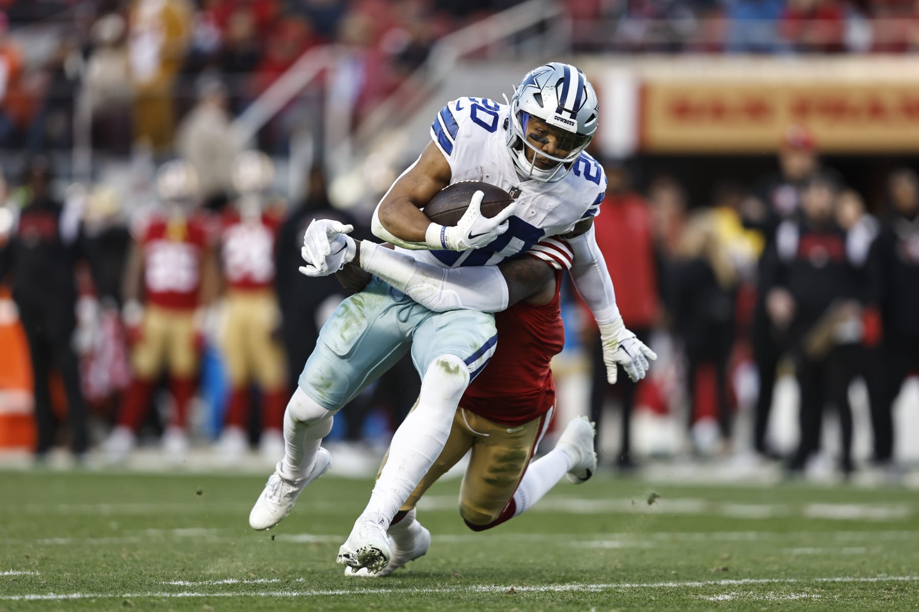 SANTA CLARA, CALIFORNIA - JANUARY 22: Tony Pollard #20 of the Dallas Cowboys is tackled by Jimmie Ward #1 of the San Francisco 49ers as he runs with the ball and gets injured during an NFL divisional round playoff football game between the San Francisco 49ers and the Dallas Cowboys at Levi's Stadium on January 22, 2023 in Santa Clara, California. (Photo by Michael Owens/Getty Images)