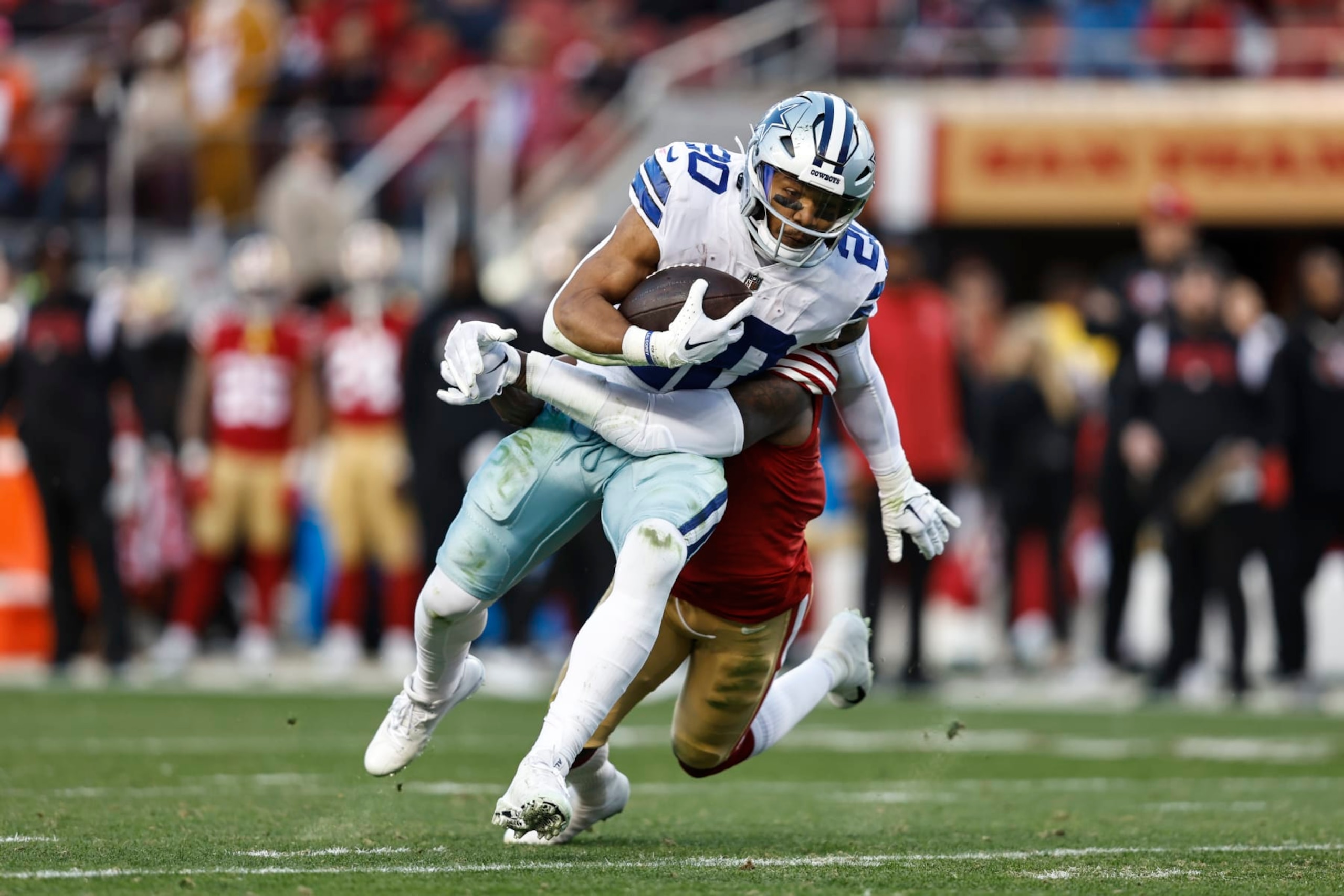 SANTA CLARA, CALIFORNIA - JANUARY 22: Tony Pollard #20 of the Dallas Cowboys is tackled by Jimmie Ward #1 of the San Francisco 49ers as he runs with the ball and gets injured during an NFL divisional round playoff football game between the San Francisco 49ers and the Dallas Cowboys at Levi's Stadium on January 22, 2023 in Santa Clara, California. (Photo by Michael Owens/Getty Images)