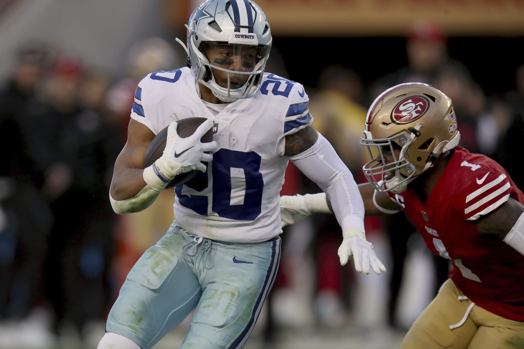 Dallas Cowboys running back Tony Pollard (20) is tackled by San Francisco 49ers cornerback Jimmie Ward (1) during an NFL divisional round playoff football game, Sunday, Jan. 22, 2023, in Santa Clara, Calif. (AP Photo/Scot Tucker)