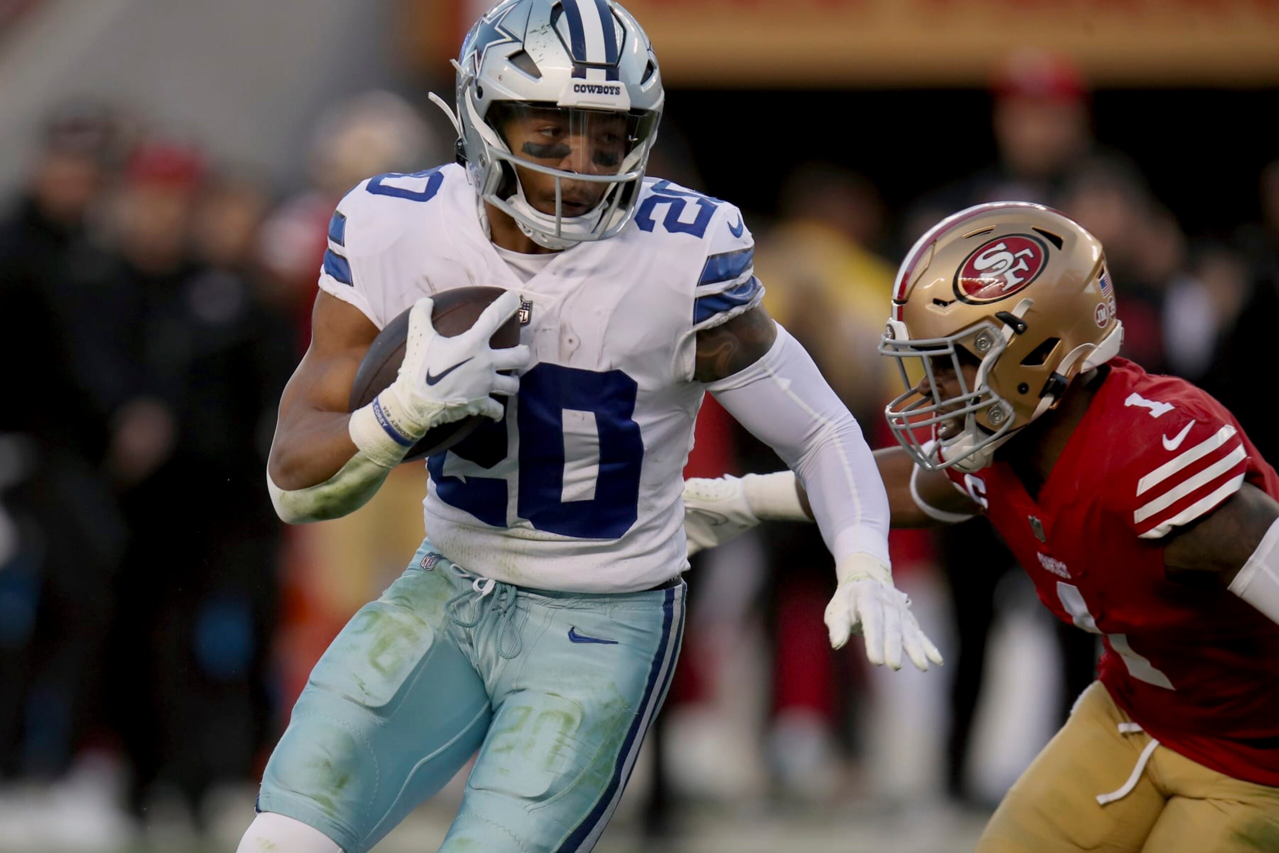 Dallas Cowboys running back Tony Pollard (20) is tackled by San Francisco 49ers cornerback Jimmie Ward (1) during an NFL divisional round playoff football game, Sunday, Jan. 22, 2023, in Santa Clara, Calif. (AP Photo/Scot Tucker)