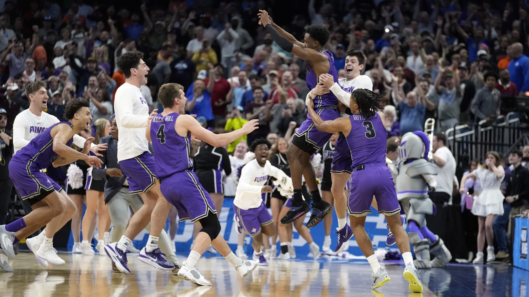 Furman celebrates its win over Virginia.